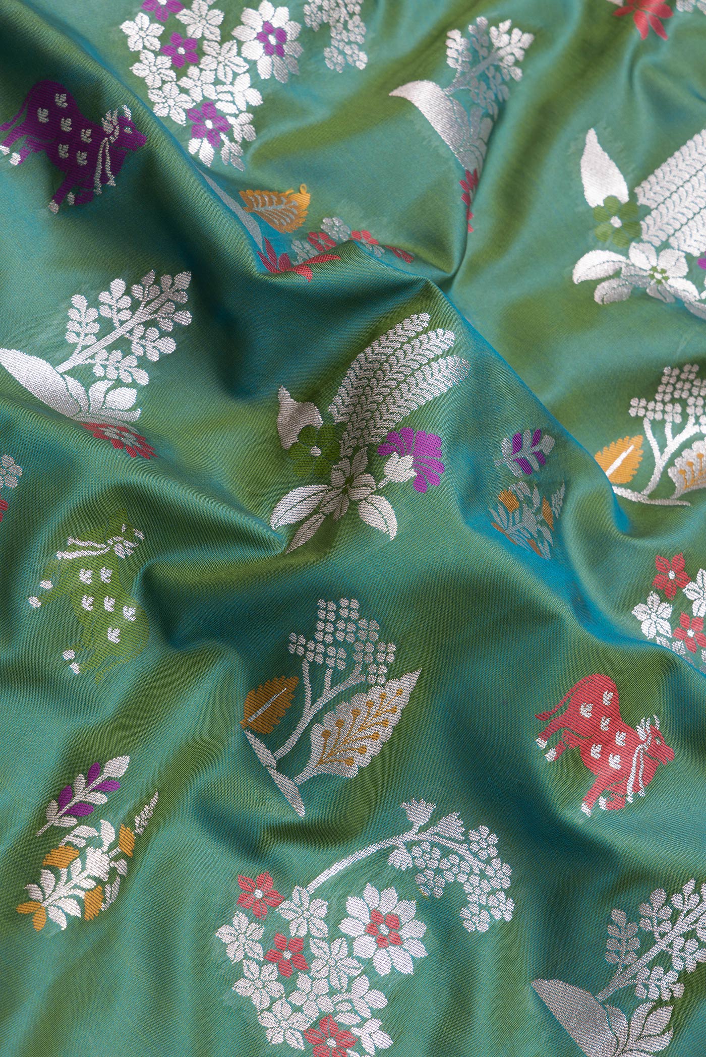 Close up of Green Dual Tone Blended Banarasi Silk Saree with Zari Brocade on the body and Zari Border.  displaying folds