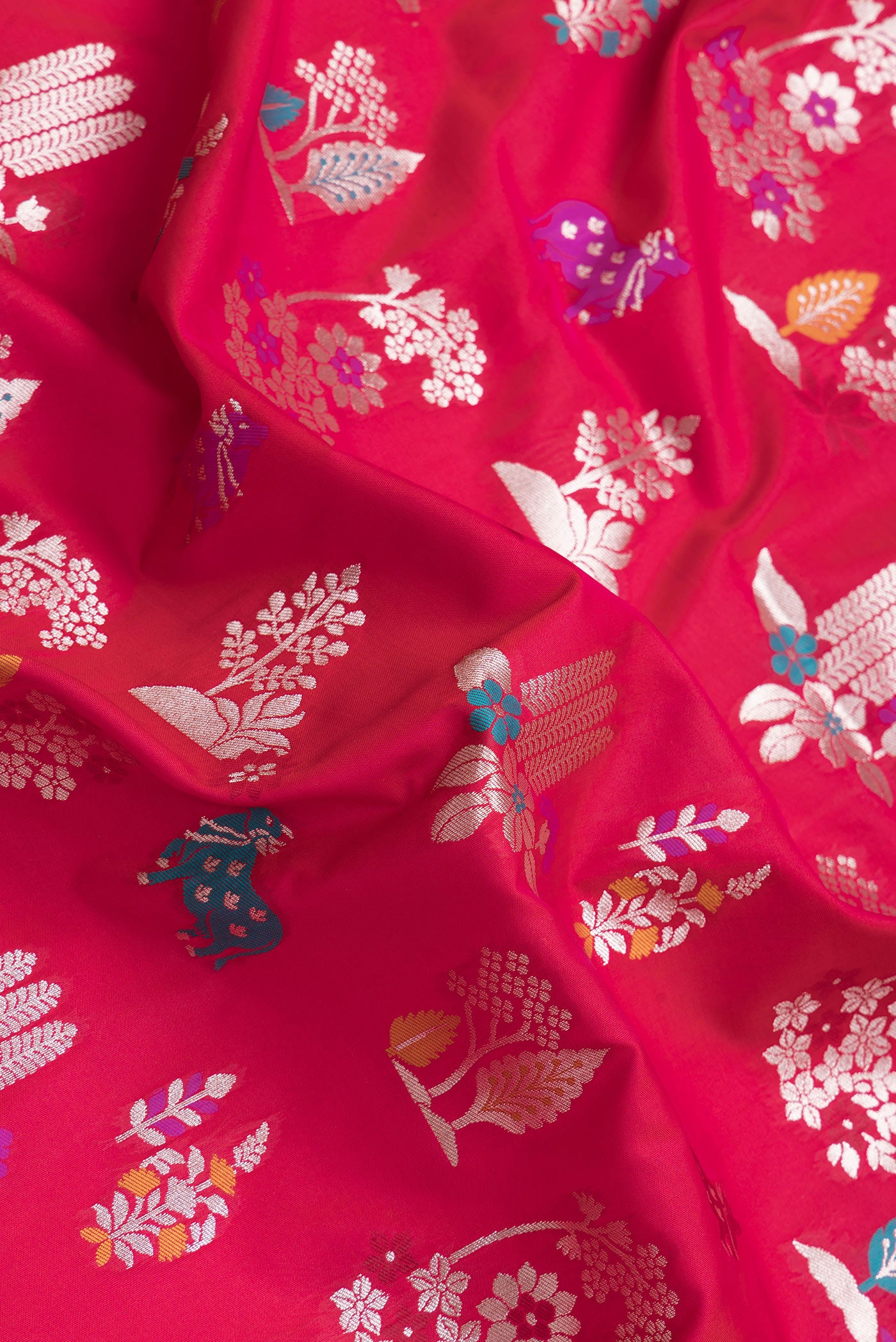 Close up of Dark Pink Dual Tone Blended Banarasi Silk Saree with Zari And Thread Butta on the body and Zari Border.  displaying folds