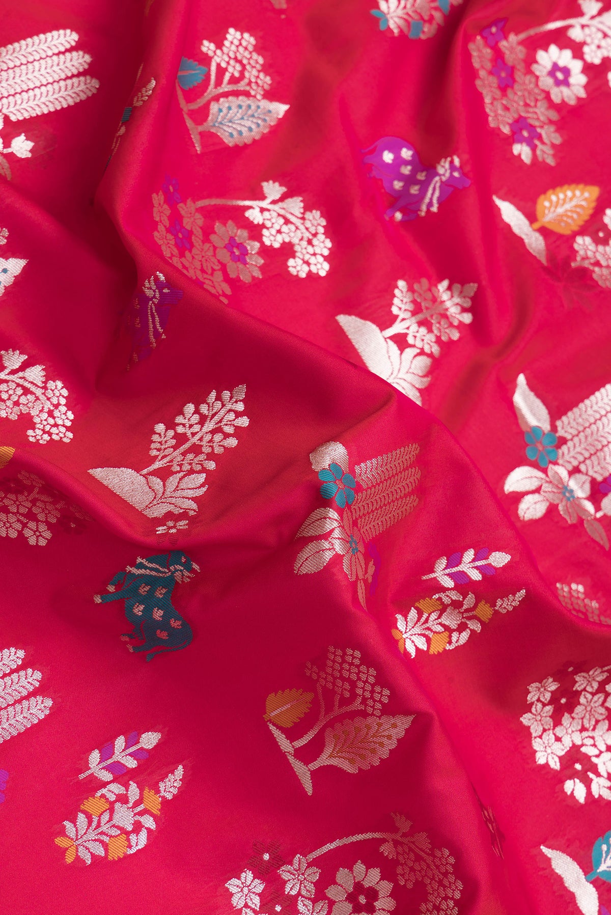 Close up of Dark Pink Dual Tone Blended Banarasi Silk Saree with Zari And Thread Butta on the body and Zari Border.  displaying folds