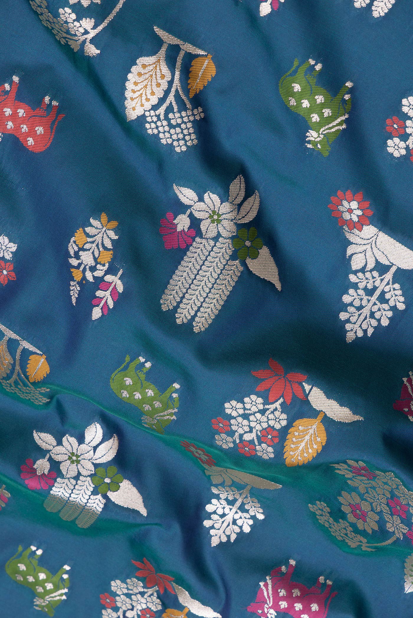 Close up of Peacock Blue Dual Tone Blended Banarasi Silk Saree with Zari Brocade on the body and Zari Border.  displaying folds
