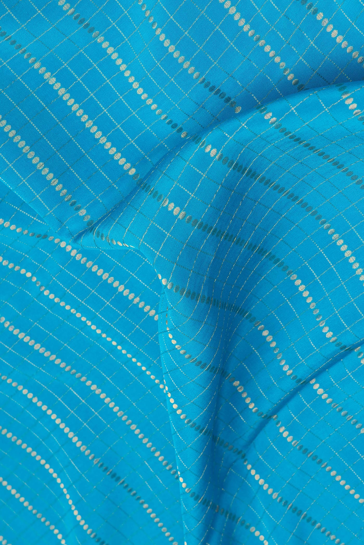 Close up of Sky Blue Mysore Silk Saree with Checked design on the body and Zari Border.  displaying folds