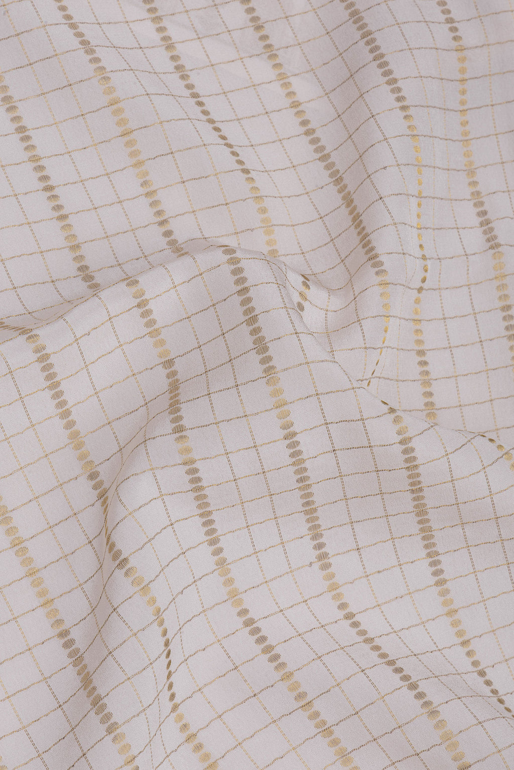 Close up of Off White Mysore Silk Saree with Checked design on the body and Zari Border.  displaying folds