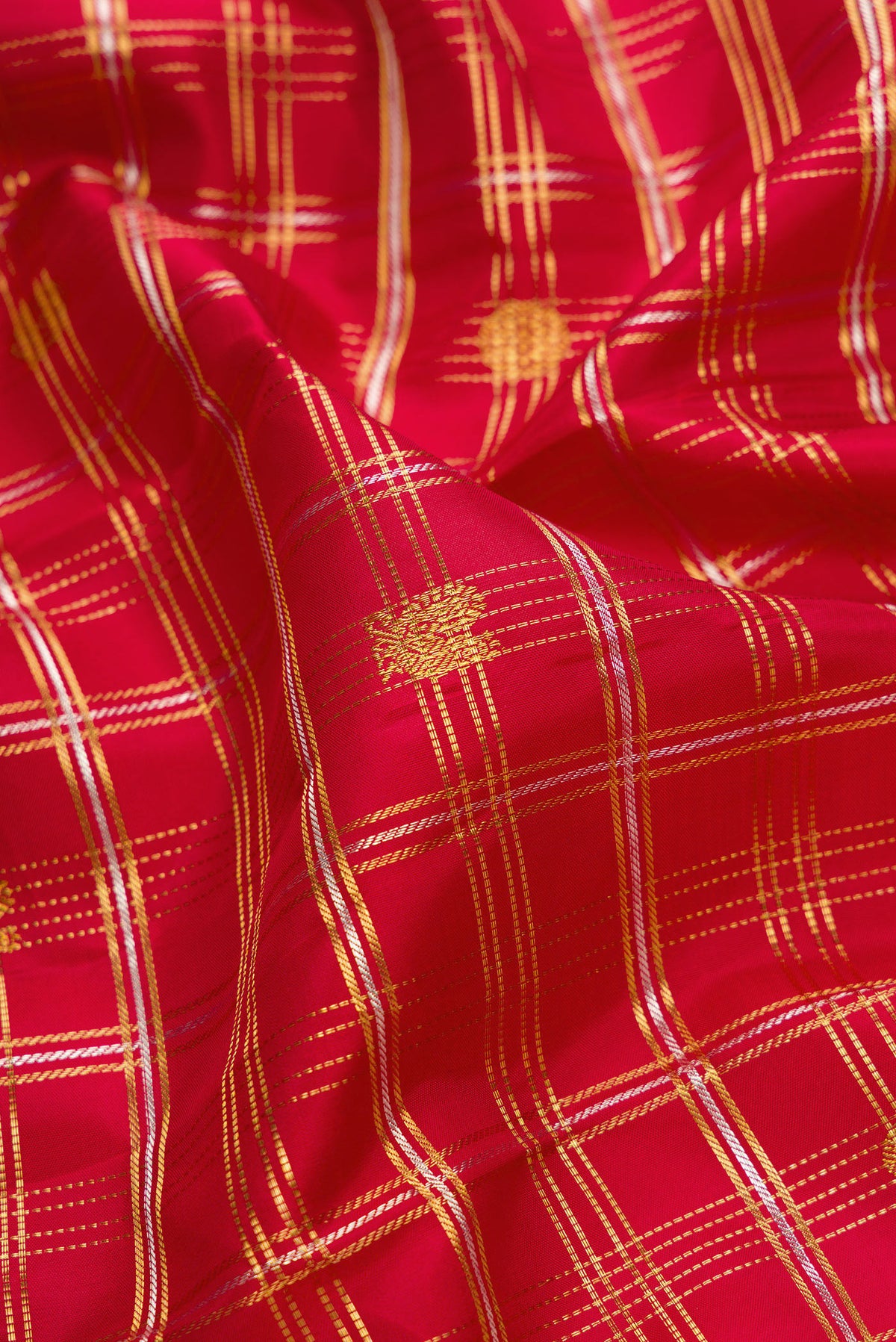 Close up of Red Dual Tone Kanjivaram Silk Saree with Checked design on the body and Zari Border.  displaying folds