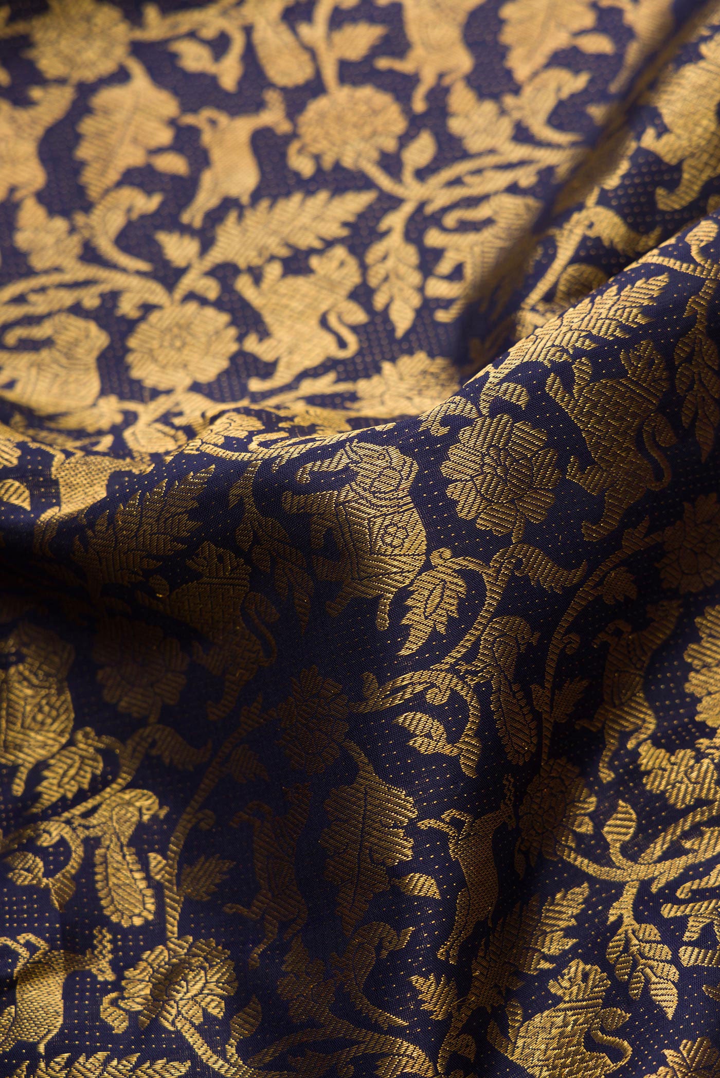 Close up of Violet Dual Tone Kanchipuram Silk Saree with Zari Brocade on the body and Zari Border.  displaying folds