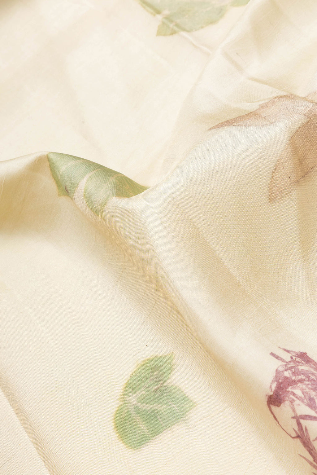 Close up of Beige Dual Tone Kanchipuram Silk Saree with Printed design on the body and Zari Border.  displaying folds