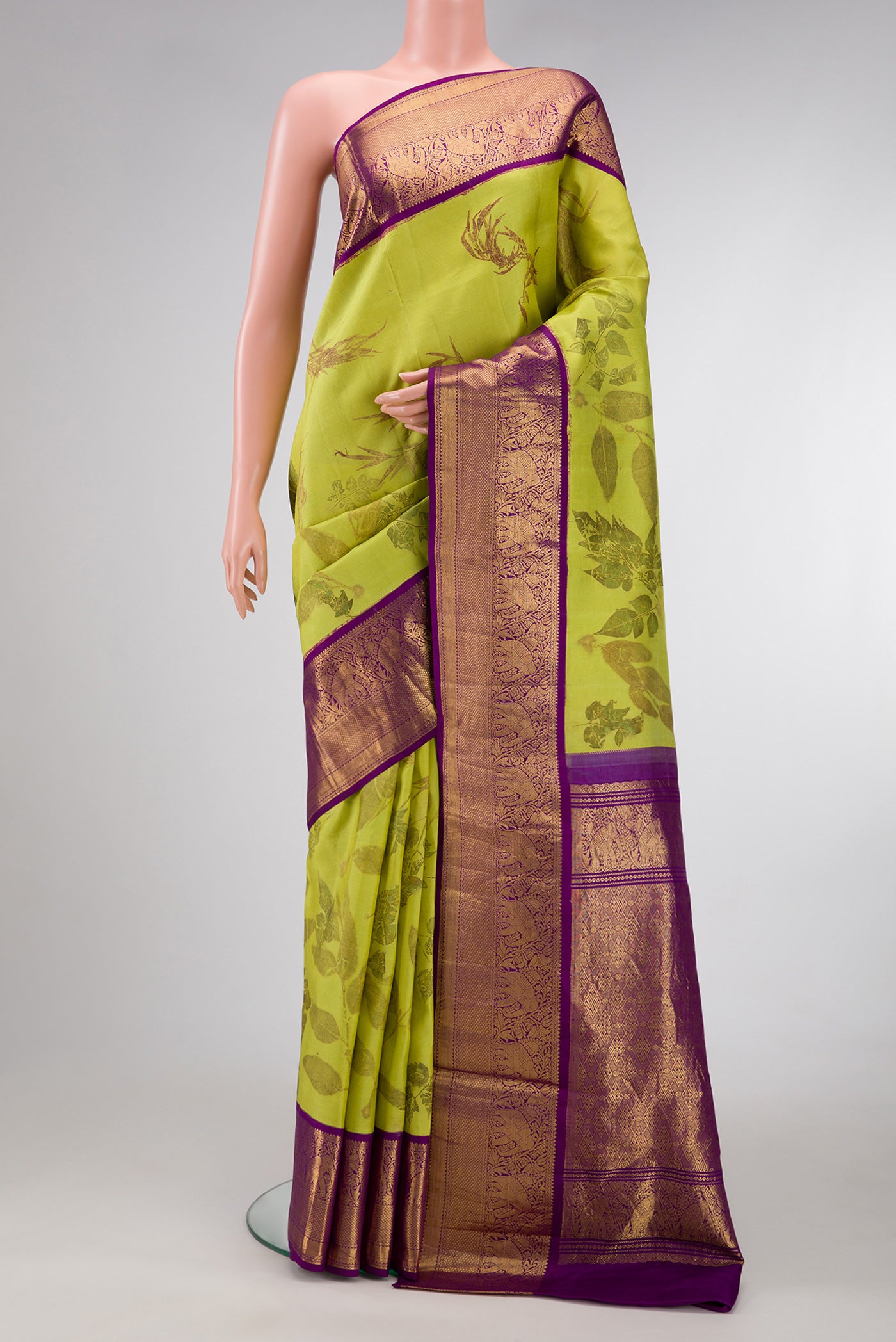 Parrot Green Dual Tone Kanchipuram Silk Saree with Printed design on the body and Zari Border.  displayed on a mannequin