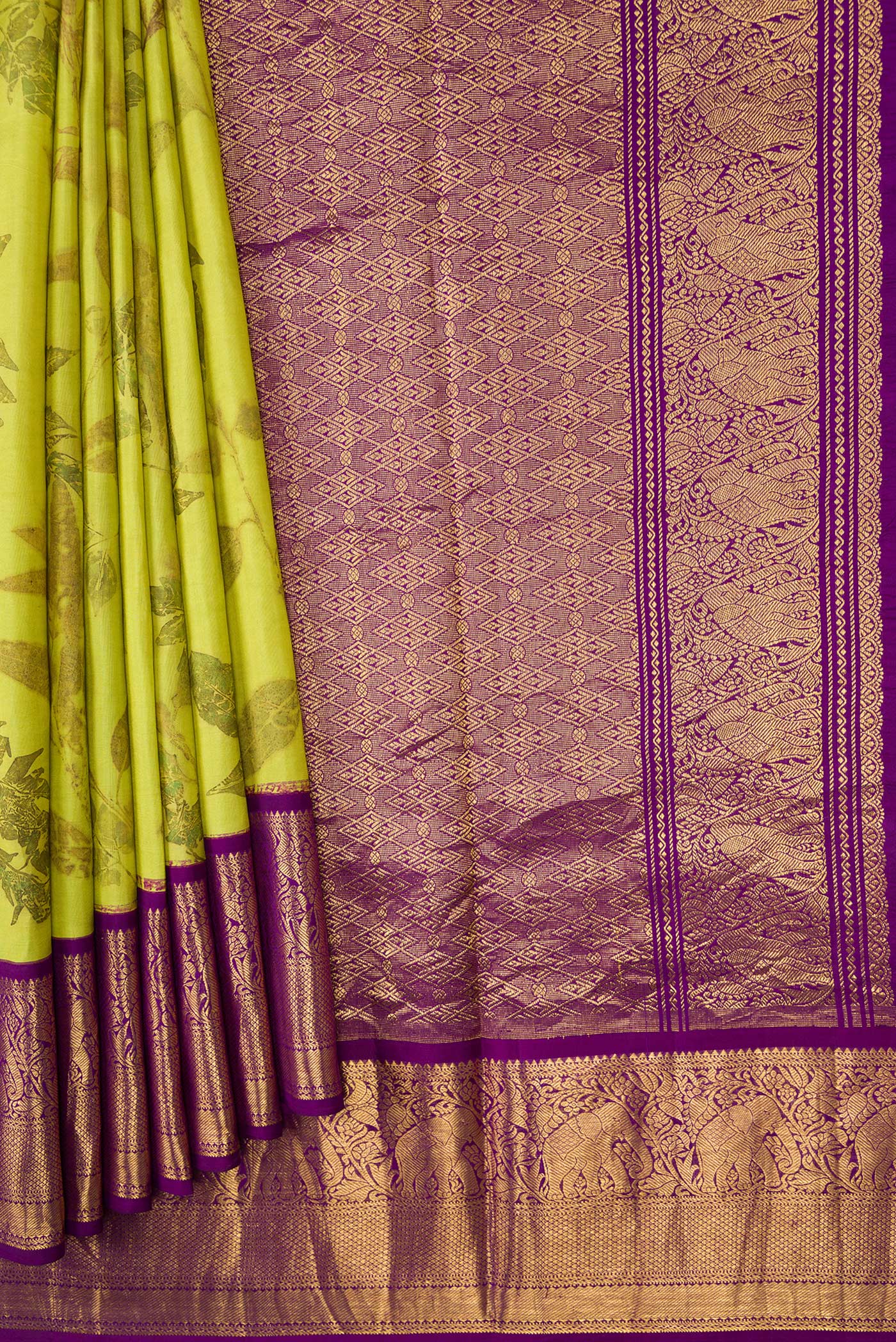 Pleats and pallu of Parrot Green Dual Tone Kanchipuram Silk Saree with Printed design on the body and Zari Border. 