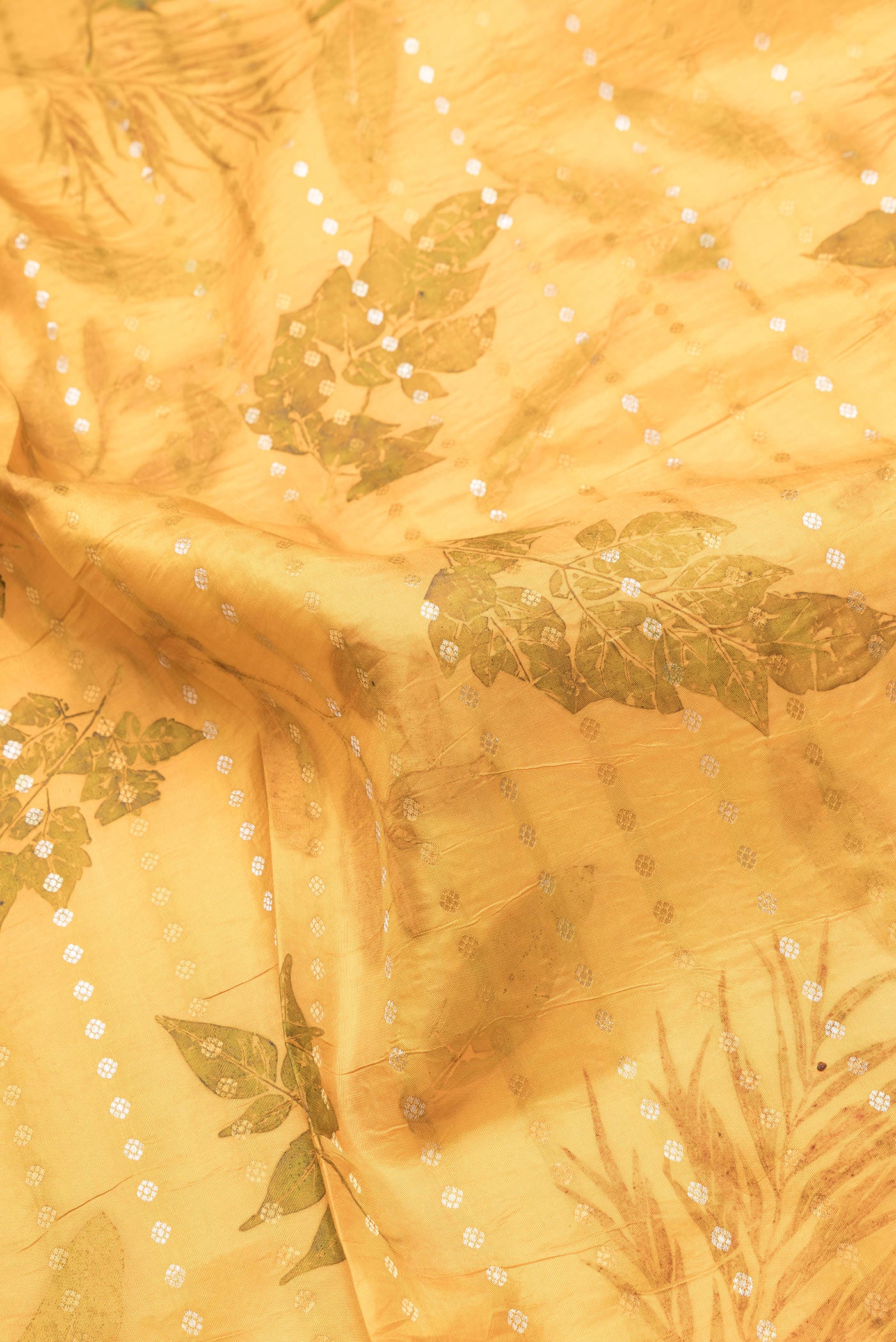 Close up of Mustard Dual Tone Kanchipuram Silk Saree with Printed design on the body and Zari Border.  displaying folds