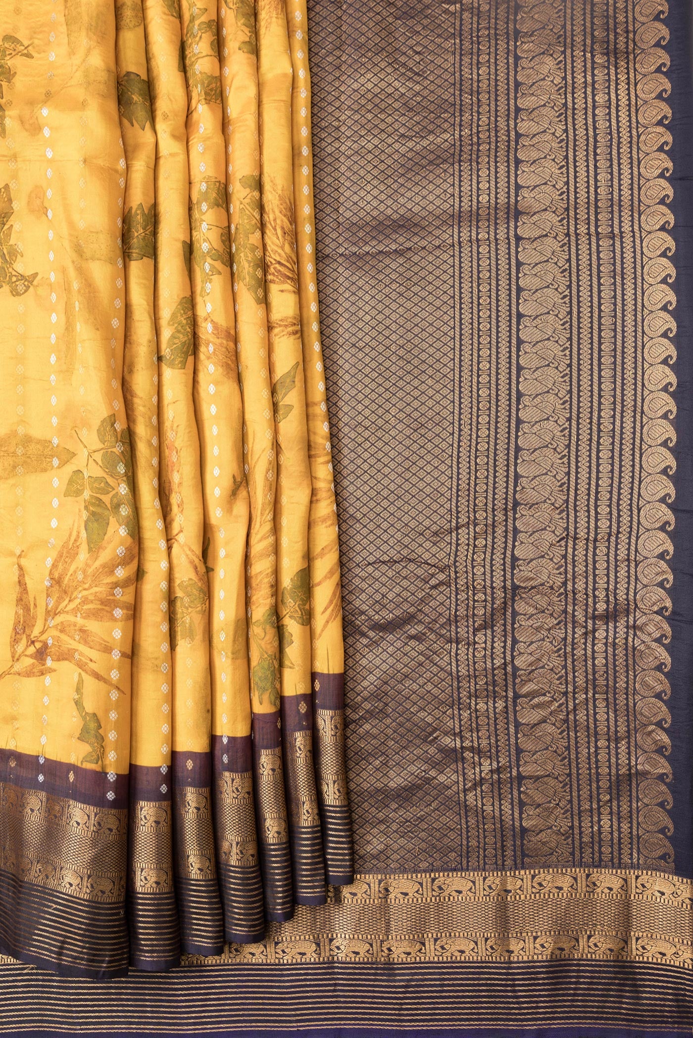 Pleats and pallu of Mustard Dual Tone Kanchipuram Silk Saree with Printed design on the body and Zari Border. 