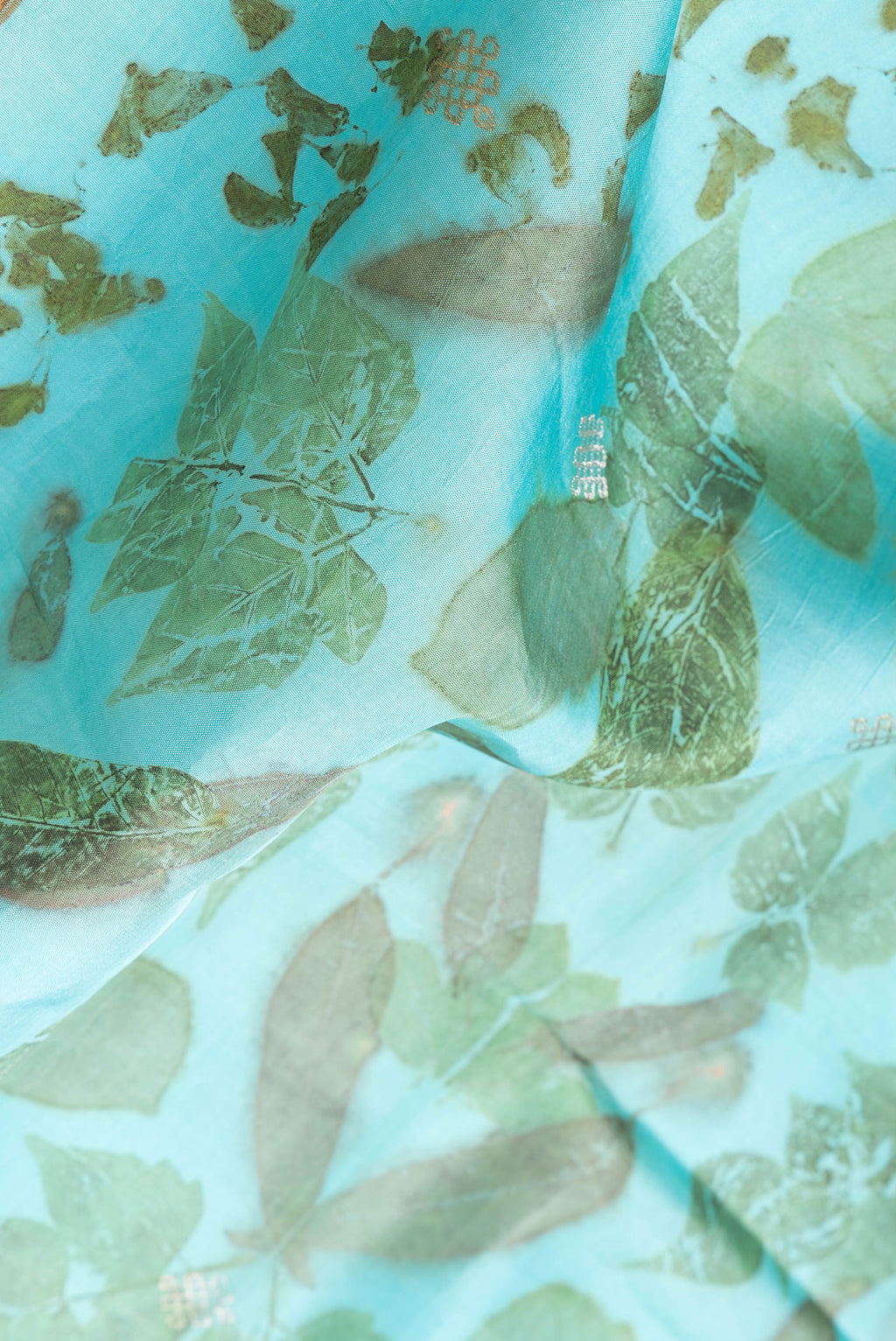 Close up of Sky Blue Dual Tone Kanchipuram Silk Saree with Printed design on the body and Zari Border.  displaying folds