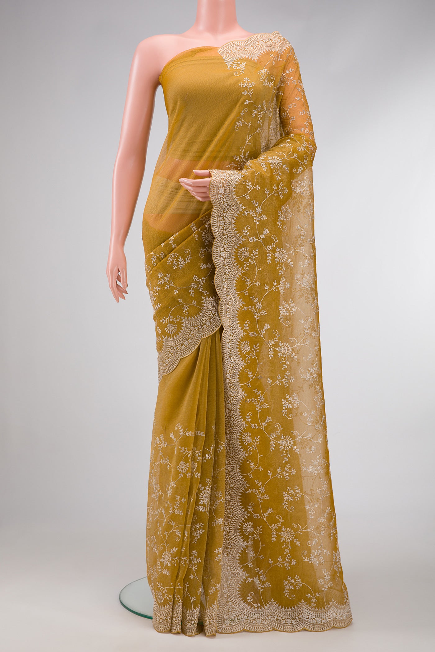 Mustard Dual Tone Organza Silk Saree with Embroidery on the body and Embroidery Border.  displayed on a mannequin