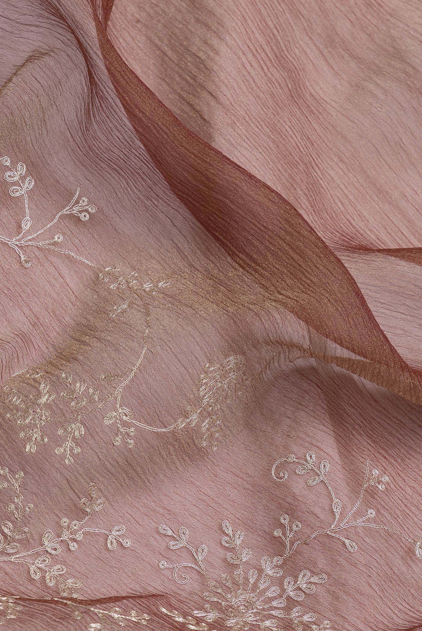 Close up of Brown Dual Tone Organza Silk Saree with Embroidery on the body and Embroidery Border.  displaying folds