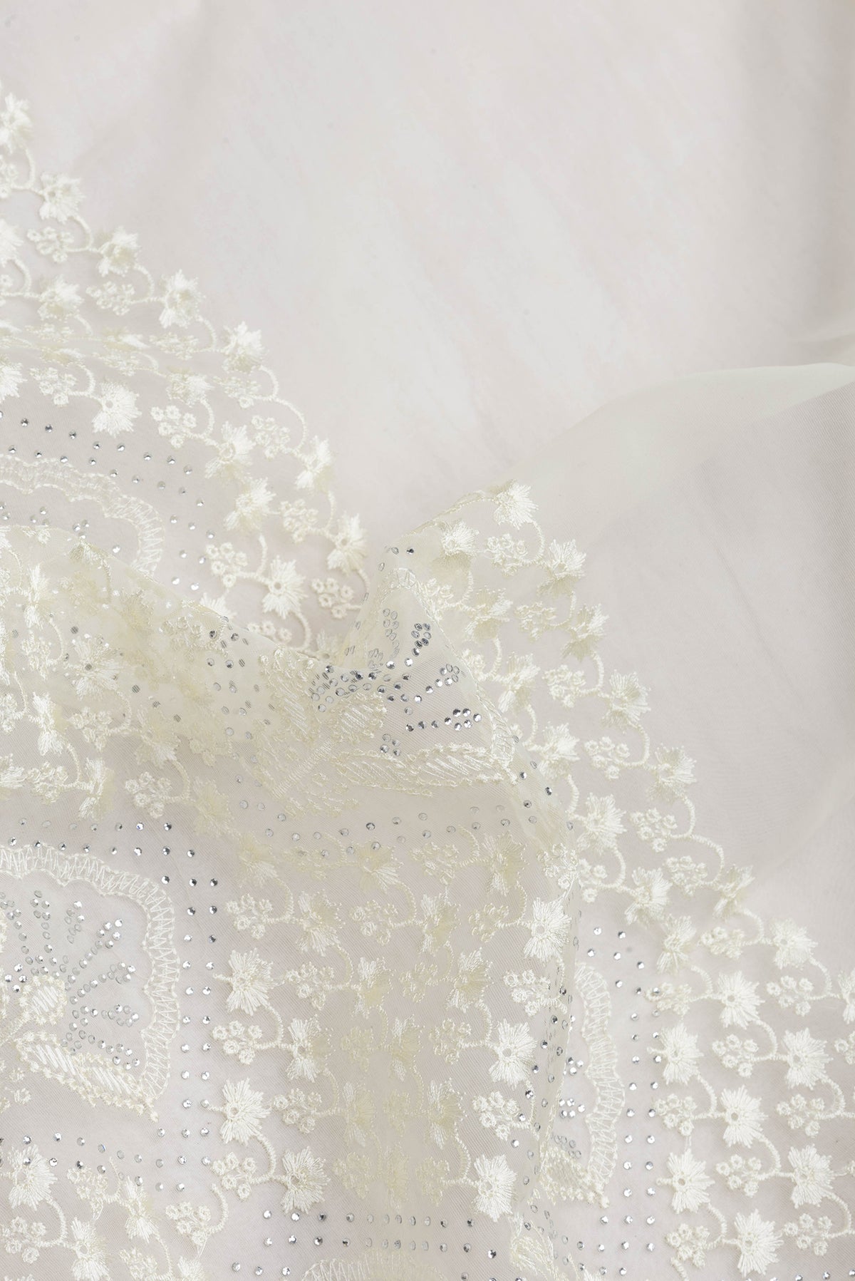 Close up of Sandal Dual Tone Organza Silk Saree with Embroidery on the body and Embroidery Border.  displaying folds