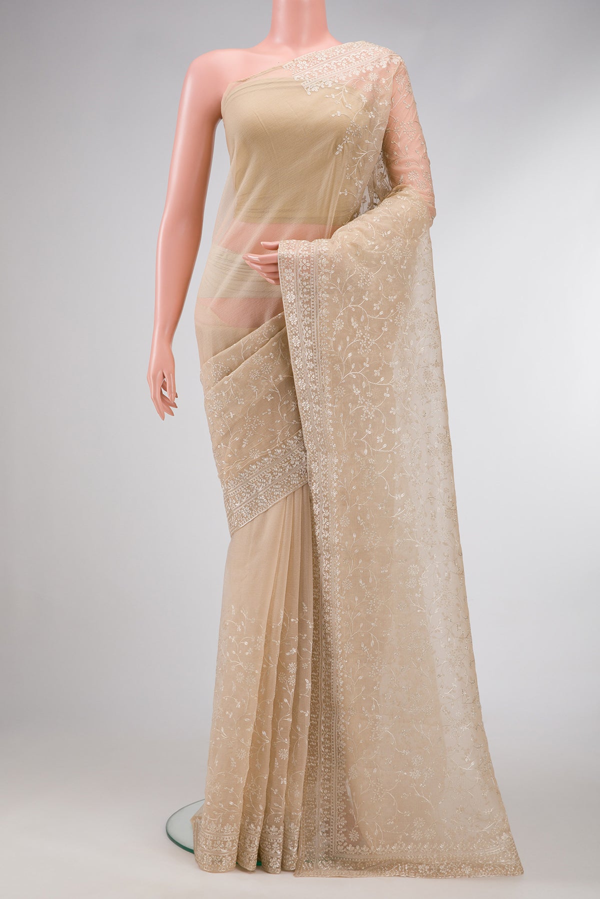 Beige Dual Tone Organza Silk Saree with Embroidery on the body and Embroidery Border.  displayed on a mannequin