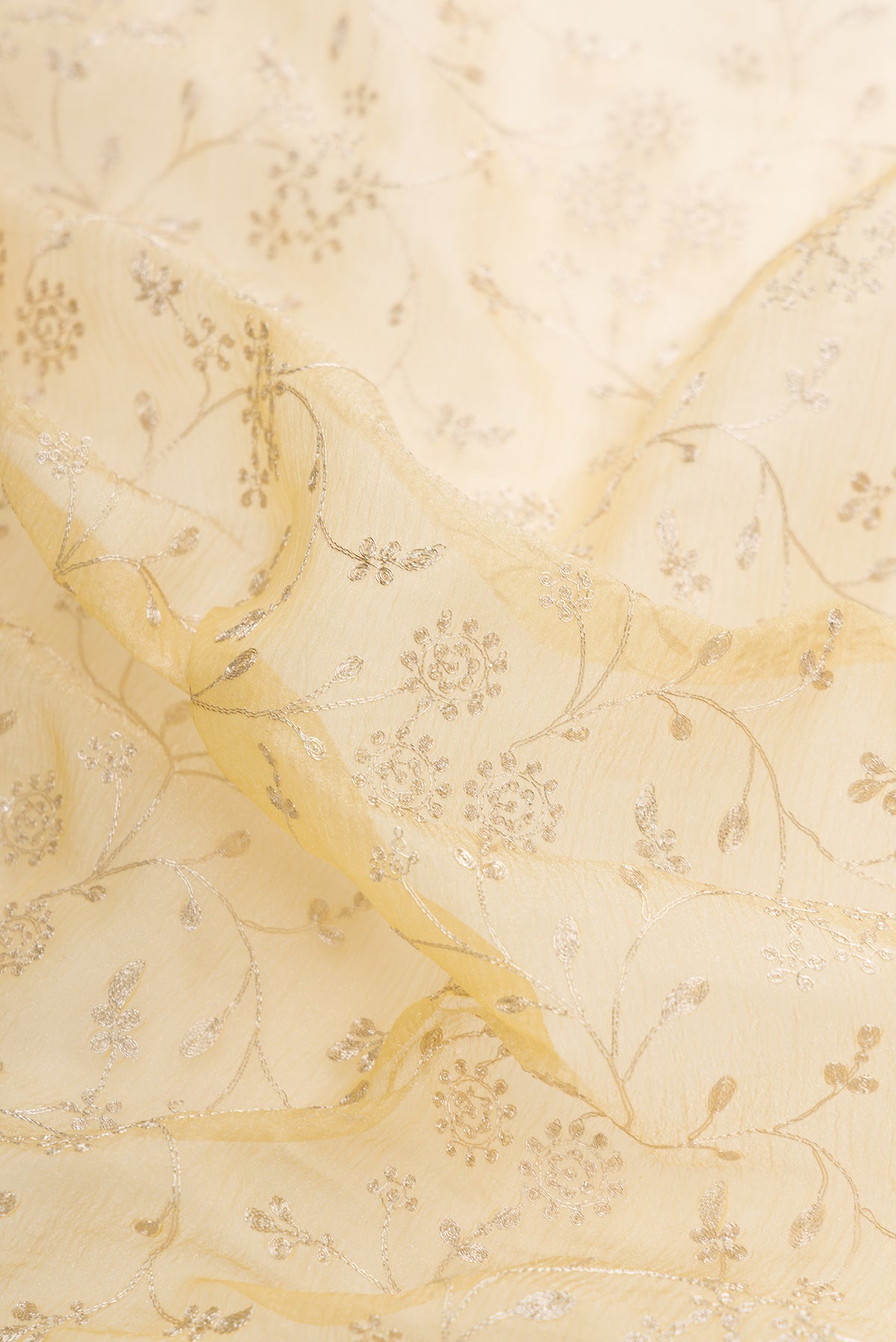 Close up of Sandal Dual Tone Organza Silk Saree with Embroidery on the body and Embroidery Border.  displaying folds