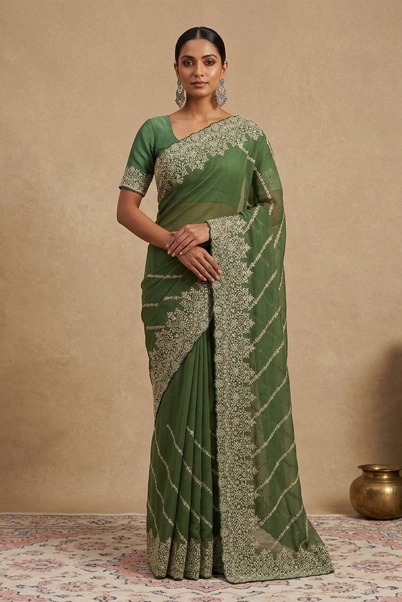 Model wearing a Green Organza Silk Saree with Embroidery on the body and Embroidery Border.