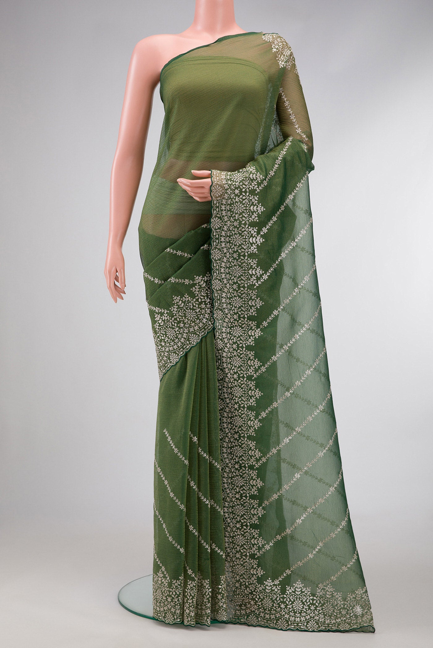 Green Dual Tone Organza Silk Saree with Embroidery on the body and Embroidery Border.  displayed on a mannequin