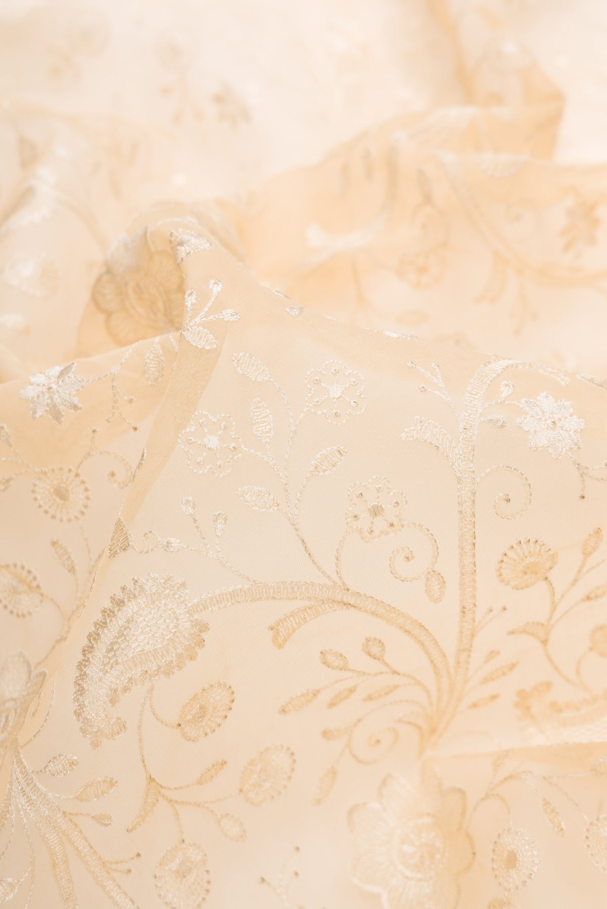 Close up of Sandal Dual Tone Organza Silk Saree with Embroidery on the body and Embroidery Border.  displaying folds