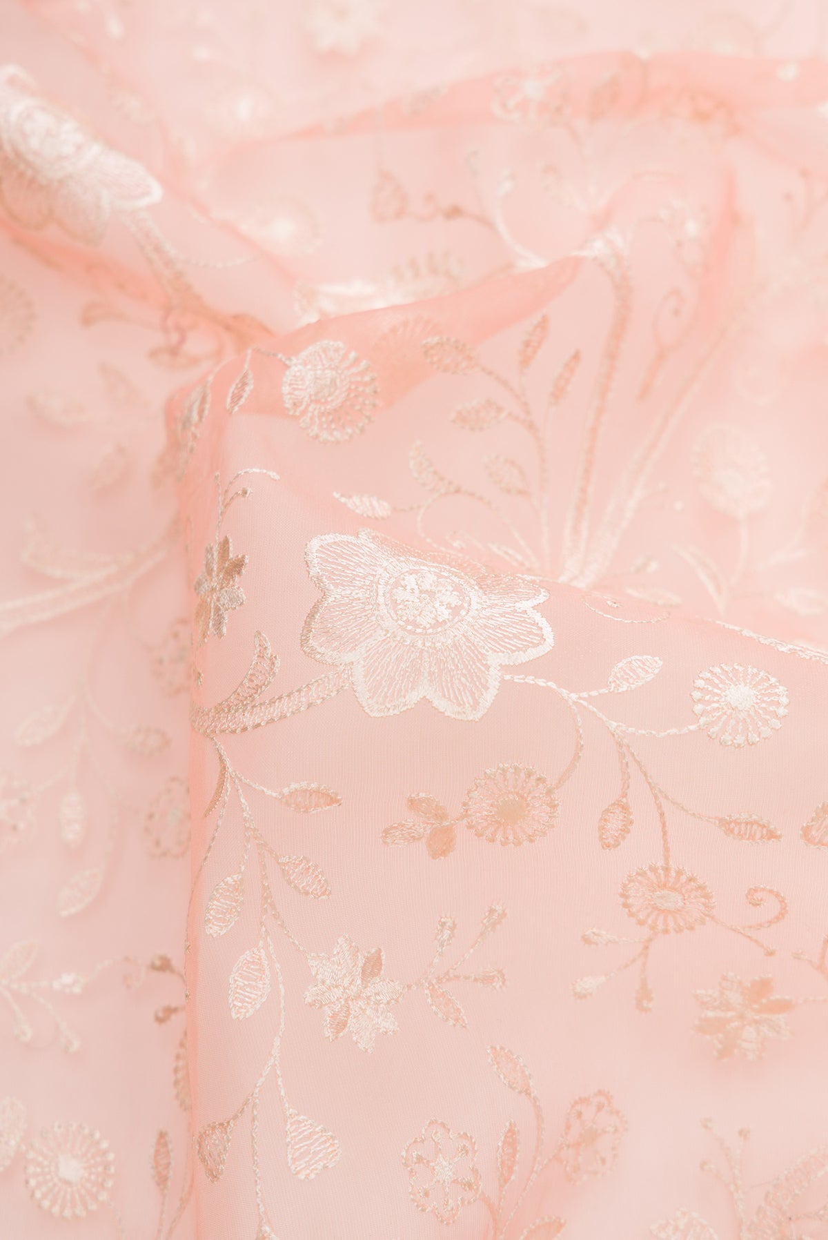 Close up of Golden Peach Dual Tone Organza Silk Saree with Embroidery on the body and Embroidery Border.  displaying folds