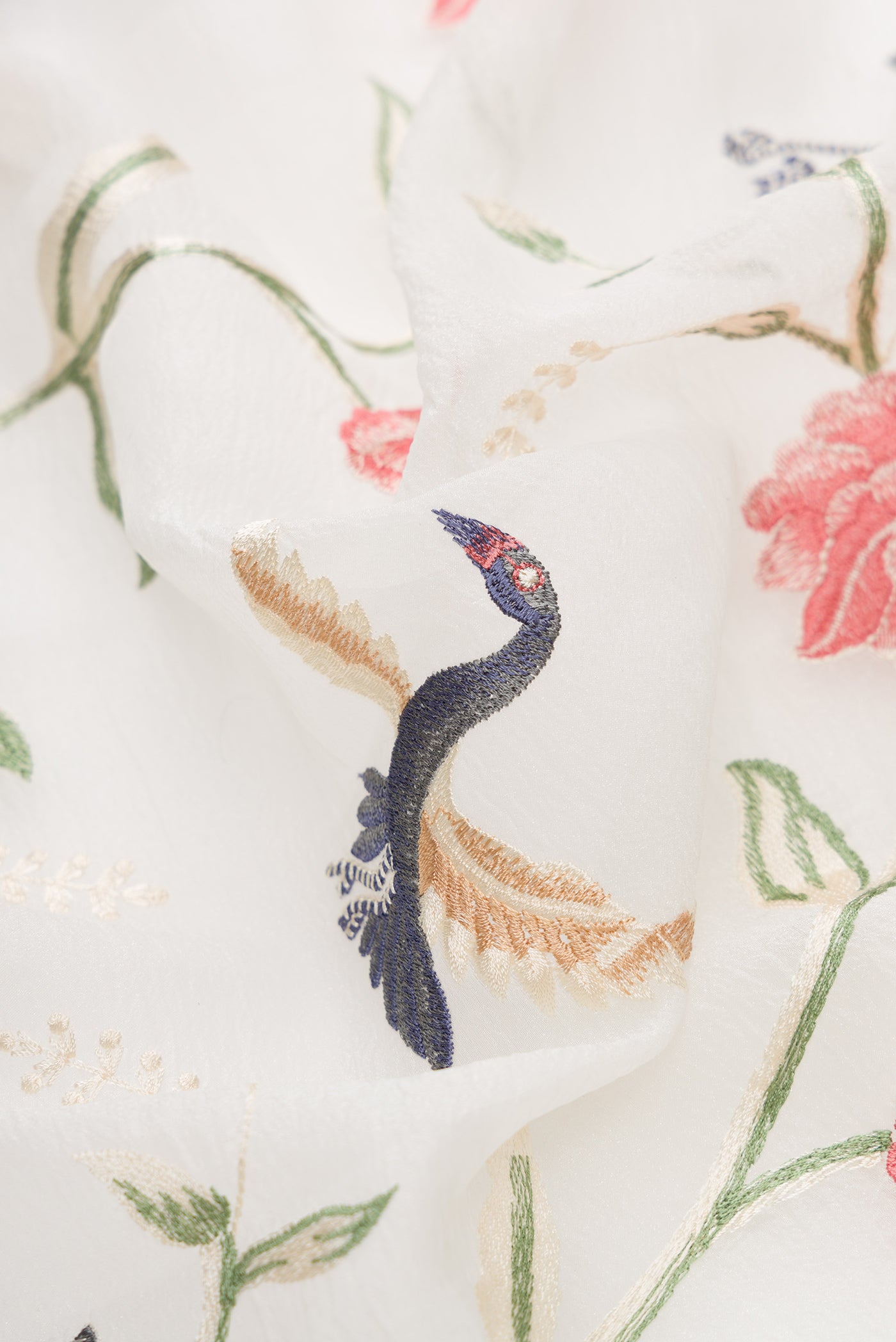 Close up of Off White Dual Tone Organza Silk Saree with Embroidery on the body and Embroidery Border.  displaying folds