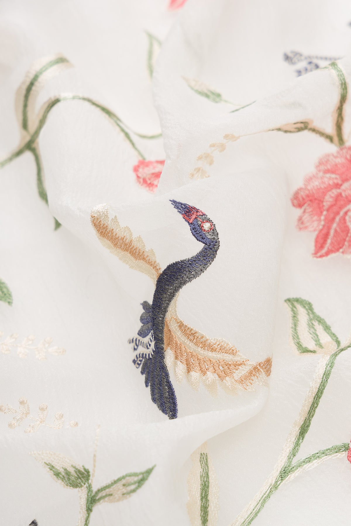 Close up of Off White Dual Tone Organza Silk Saree with Embroidery on the body and Embroidery Border.  displaying folds