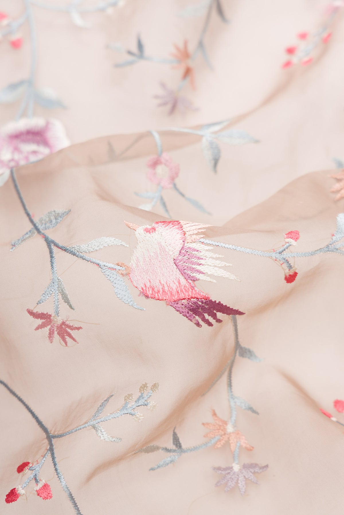 Close up of Brown Dual Tone Organza Silk Saree with Embroidery on the body and Embroidery Border.  displaying folds