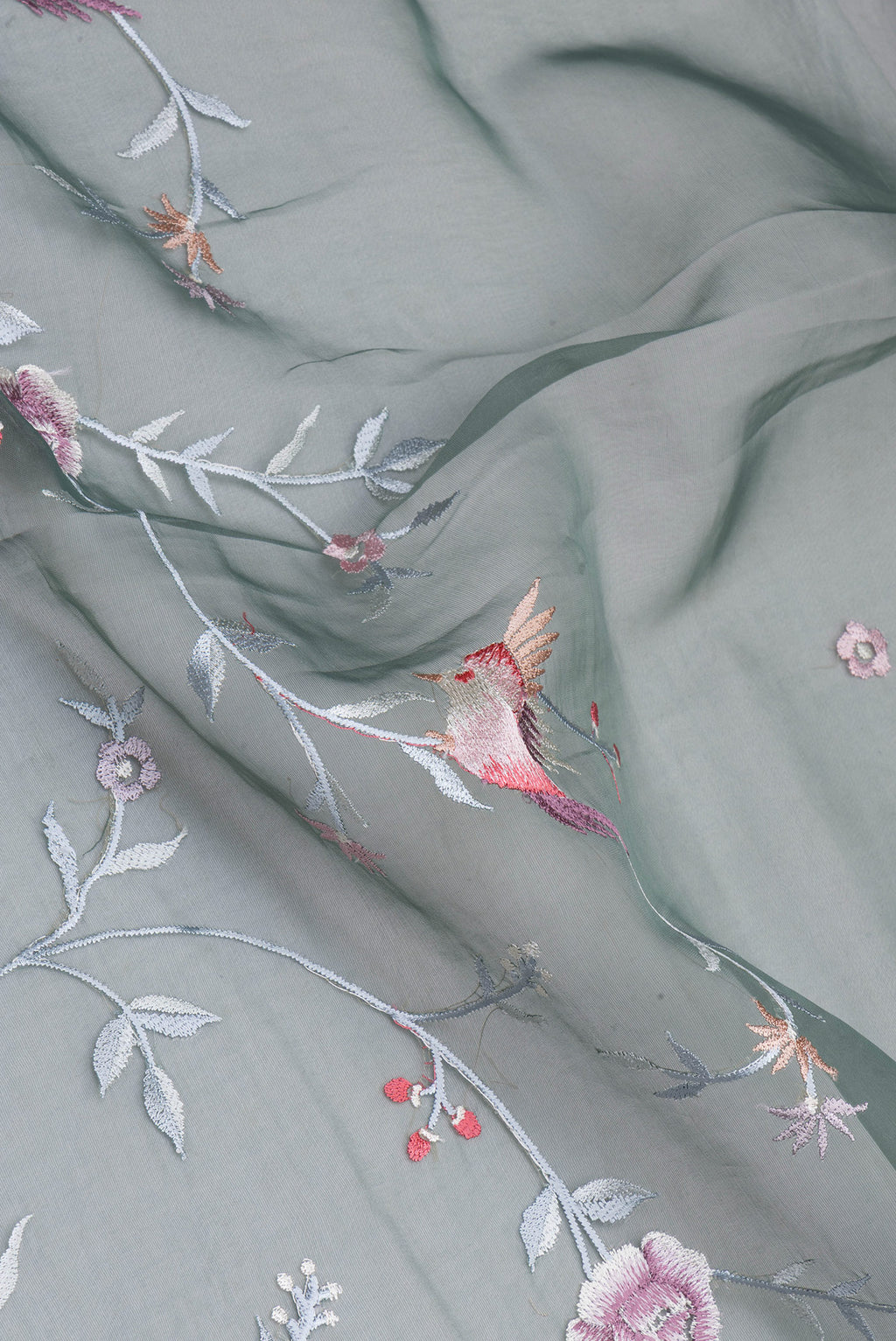 Close up of Green Blended Organza Silk Saree with Embroidery on the body and Embroidery Border.  displaying folds