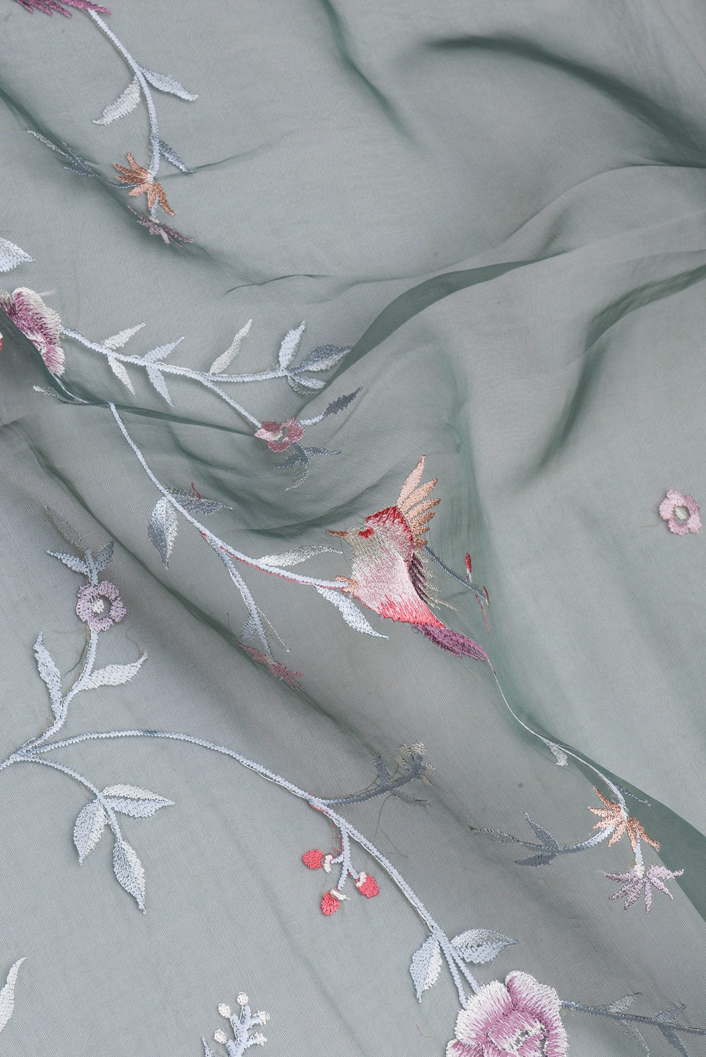 Close up of Green Blended Organza Silk Saree with Embroidery on the body and Embroidery Border.  displaying folds