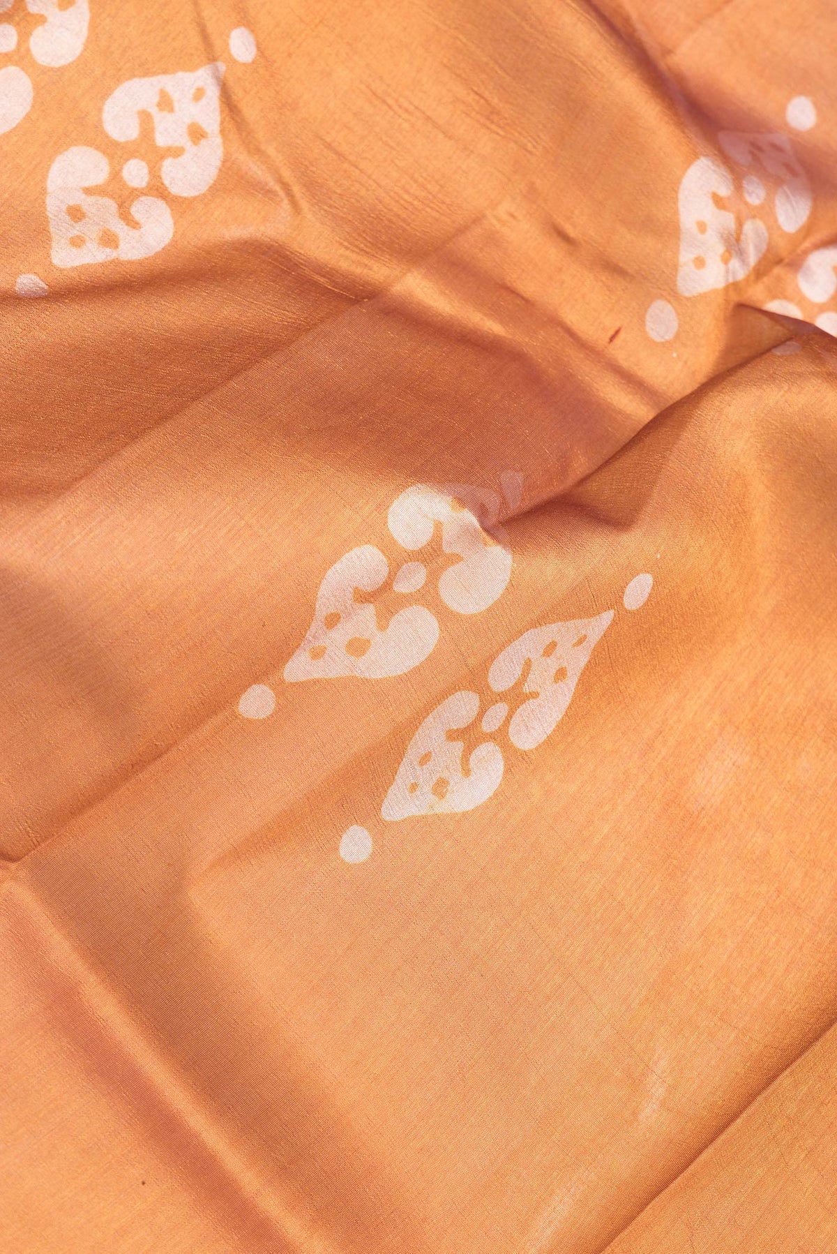Close up of Mustard Dual Tone Tussar Silk Saree with Printed design on the body and Printed Border.  displaying folds