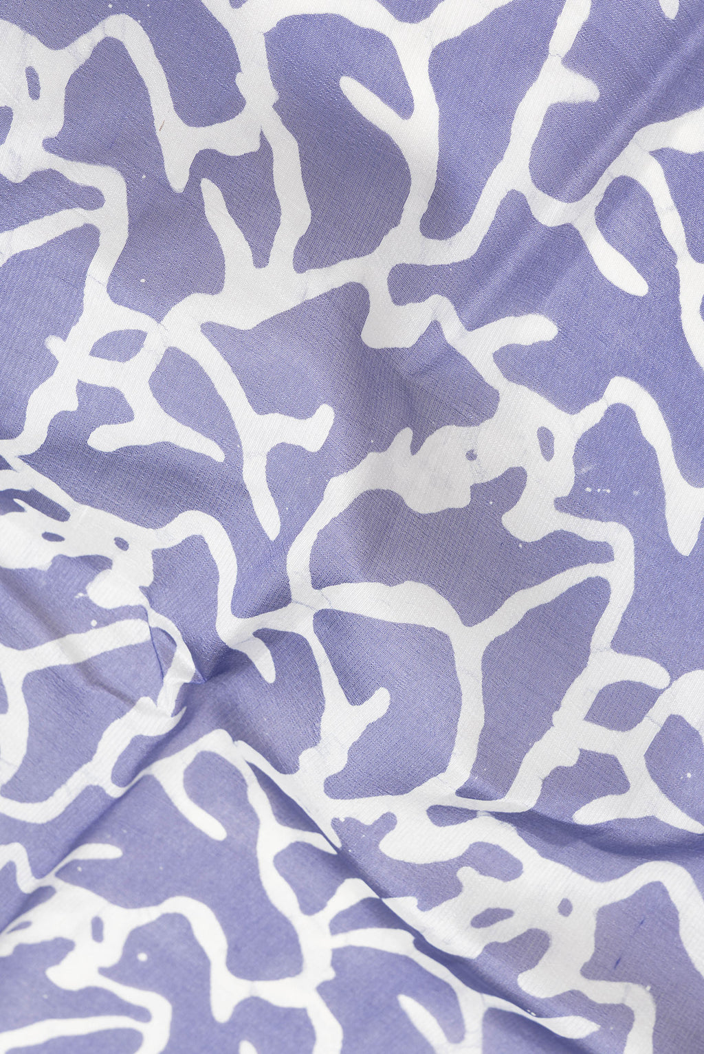 Close up of Violet Dual Tone Tussar Silk Saree with Printed design on the body and Printed Border.  displaying folds
