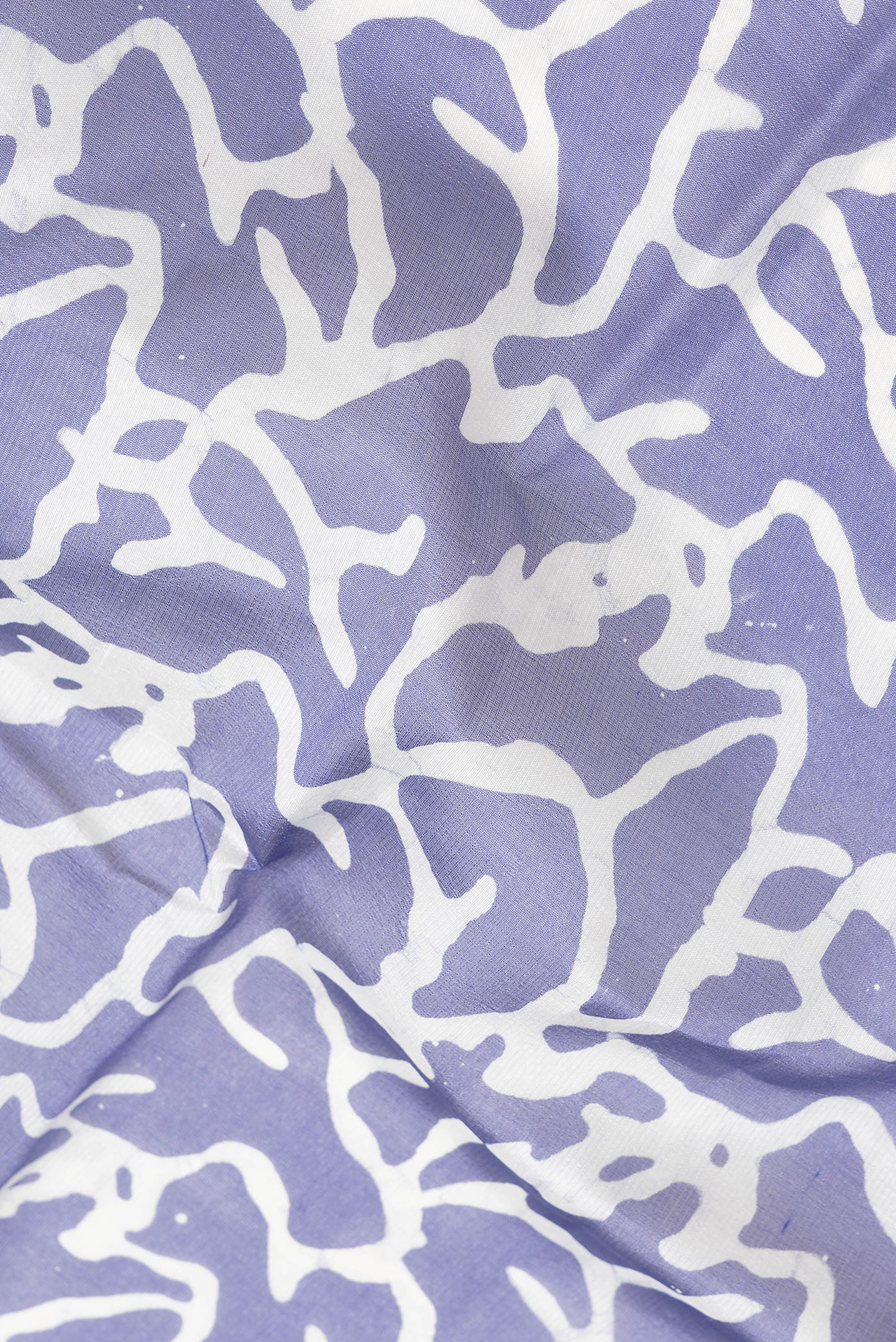 Close up of Violet Dual Tone Tussar Silk Saree with Printed design on the body and Printed Border.  displaying folds