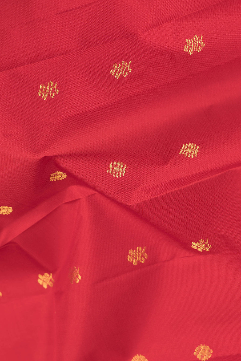 Close up of Maroon Dual Tone Kanchipuram Silk Saree with Zari Butta on the body and Zari Border.  displaying folds