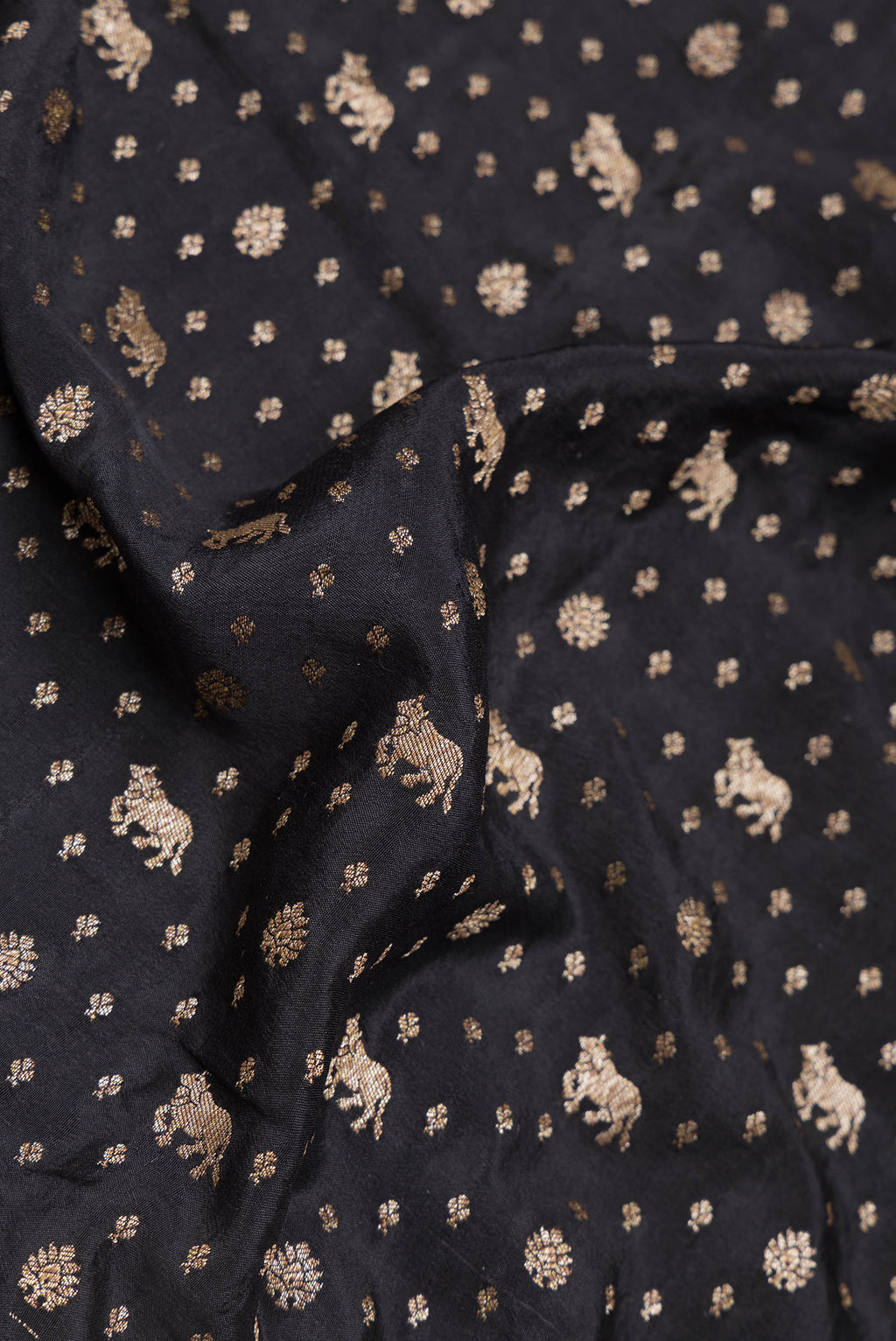 Close up of Black Dual Tone Banarasi Georgette Saree with Zari Butta on the body and Zari Border.  displaying folds