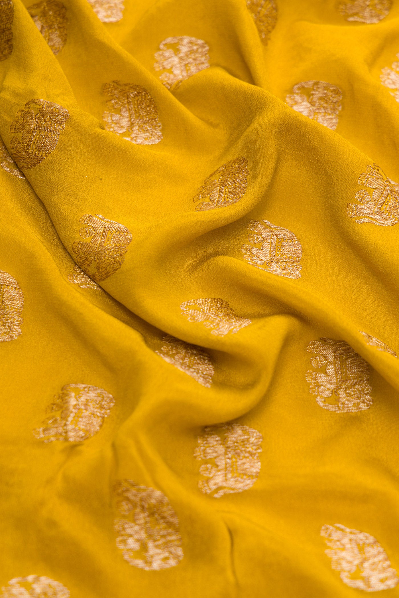 Close up of Green Dual Tone Mysore Georgette Saree with Zari Butta on the body and Zari Border.  displaying folds