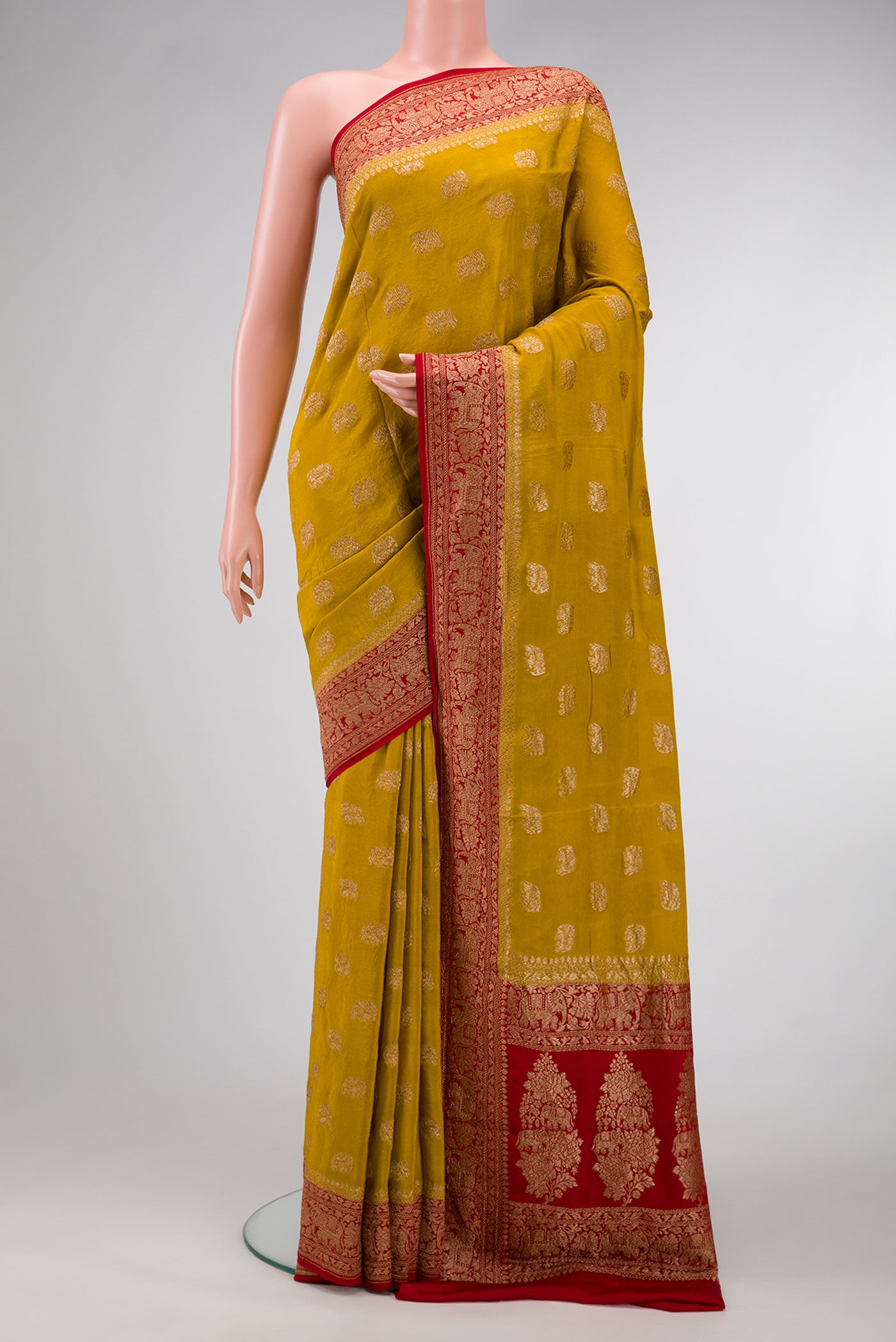 Green Dual Tone Mysore Georgette Saree with Zari Butta on the body and Zari Border.  displayed on a mannequin