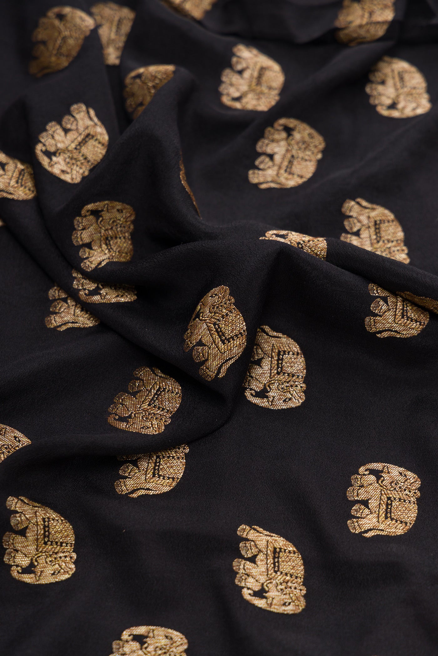 Close up of Black Dual Tone Georgette Saree with Zari Butta on the body and Zari Border.  displaying folds