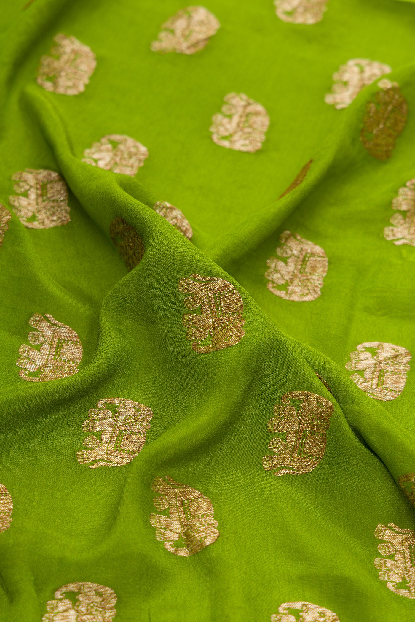 Close up of Green Dual Tone Mysore Georgette Saree with Zari Butta on the body and Zari Border.  displaying folds