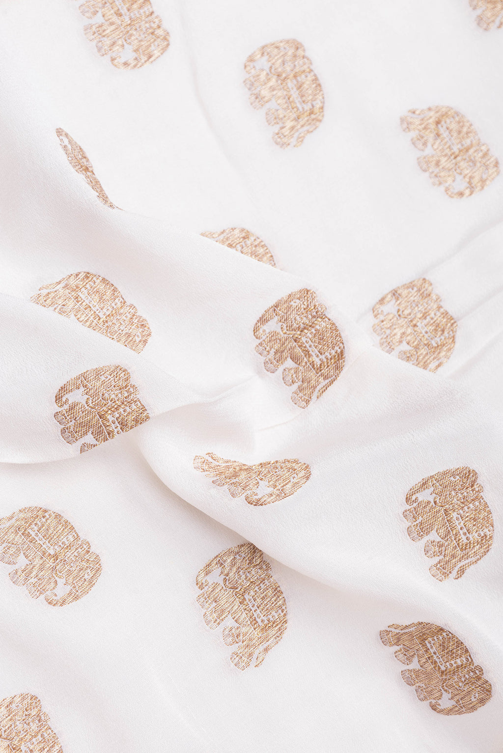 Close up of Off White Banarasi Georgette Saree with Zari Butta on the body and Zari Border.  displaying folds