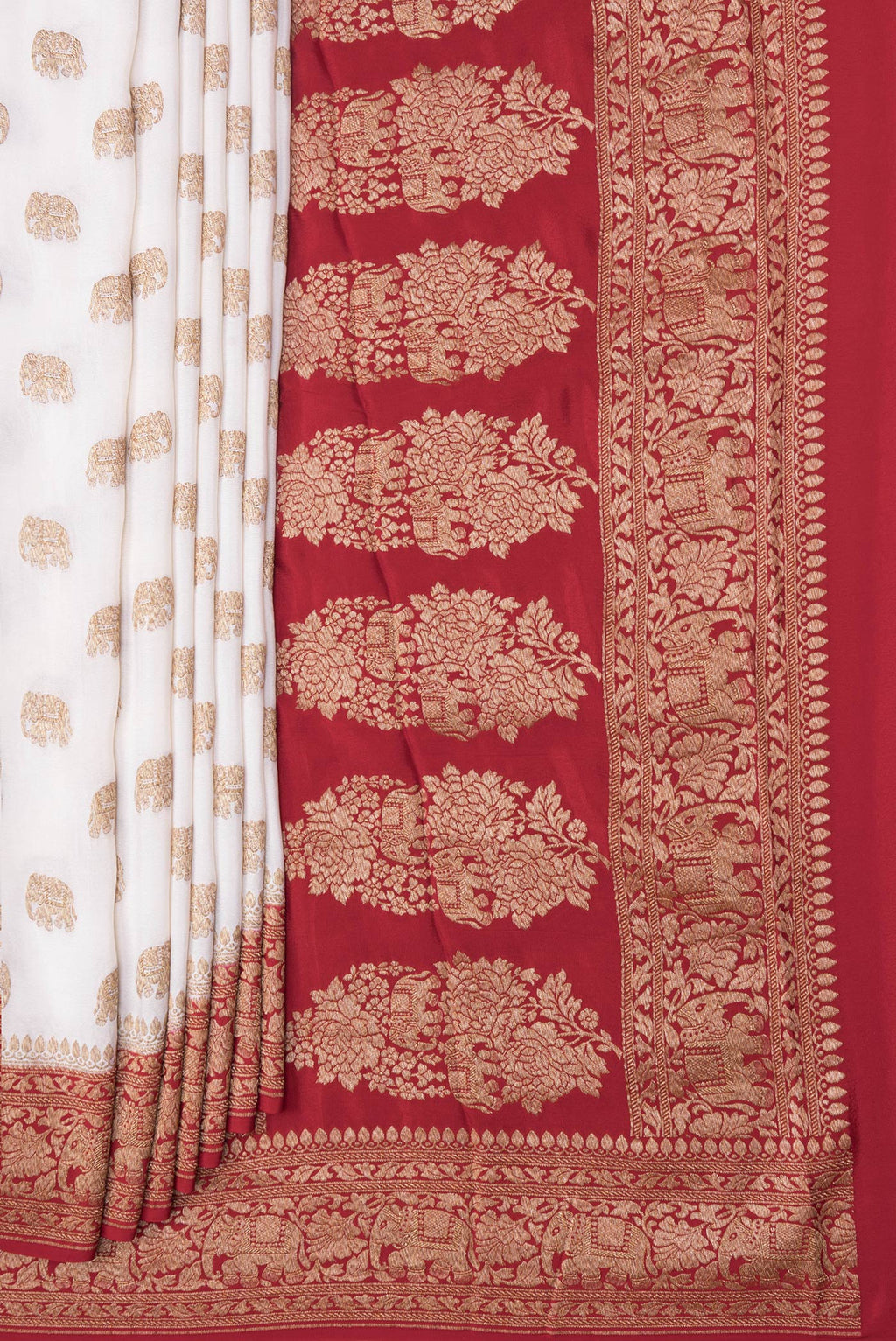 Pleats and pallu of Off White Banarasi Georgette Saree with Zari Butta on the body and Zari Border. 
