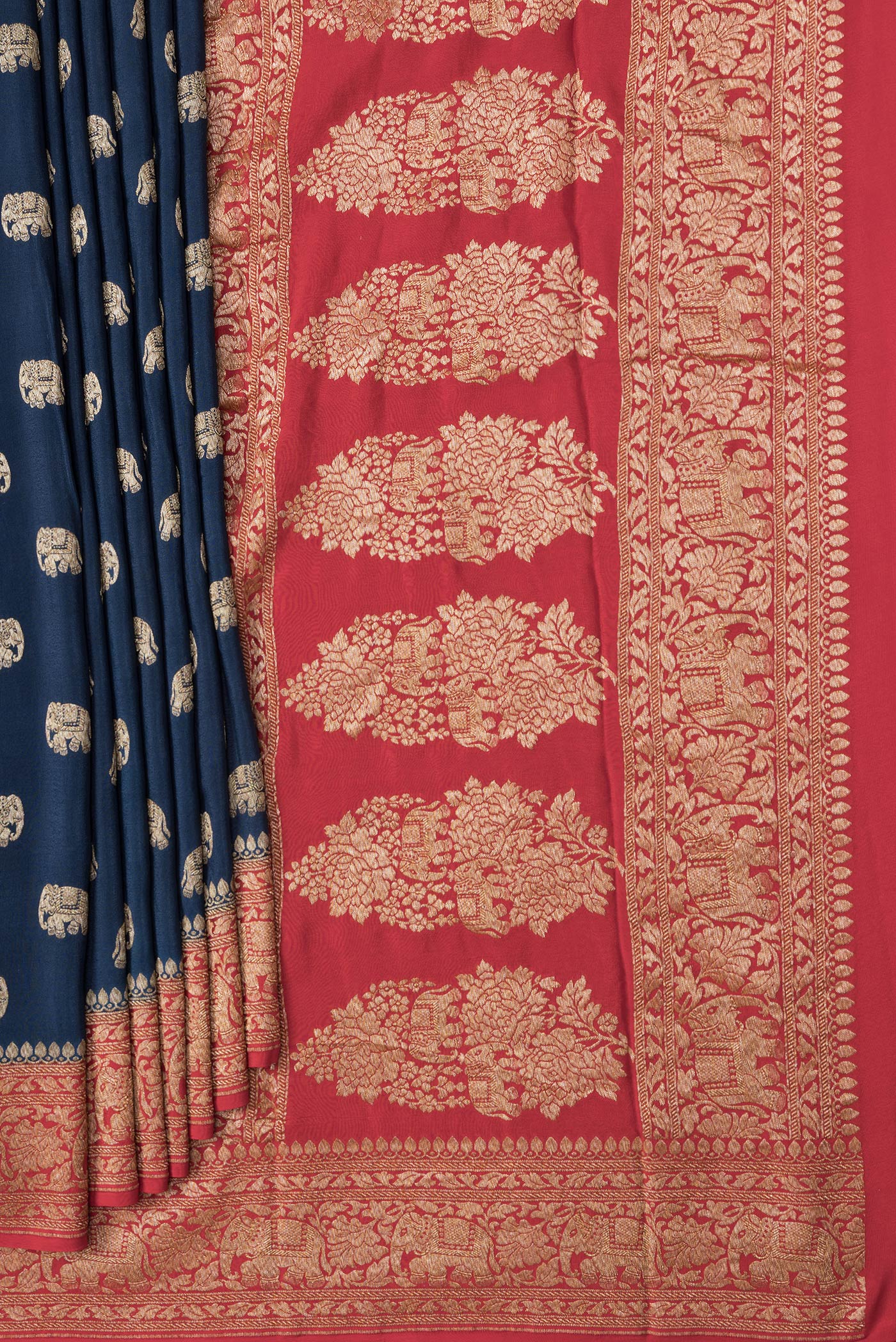 Pleats and pallu of Navy Blue Dual Tone Banarasi Georgette Saree with Zari Butta on the body and Fancy Border. 