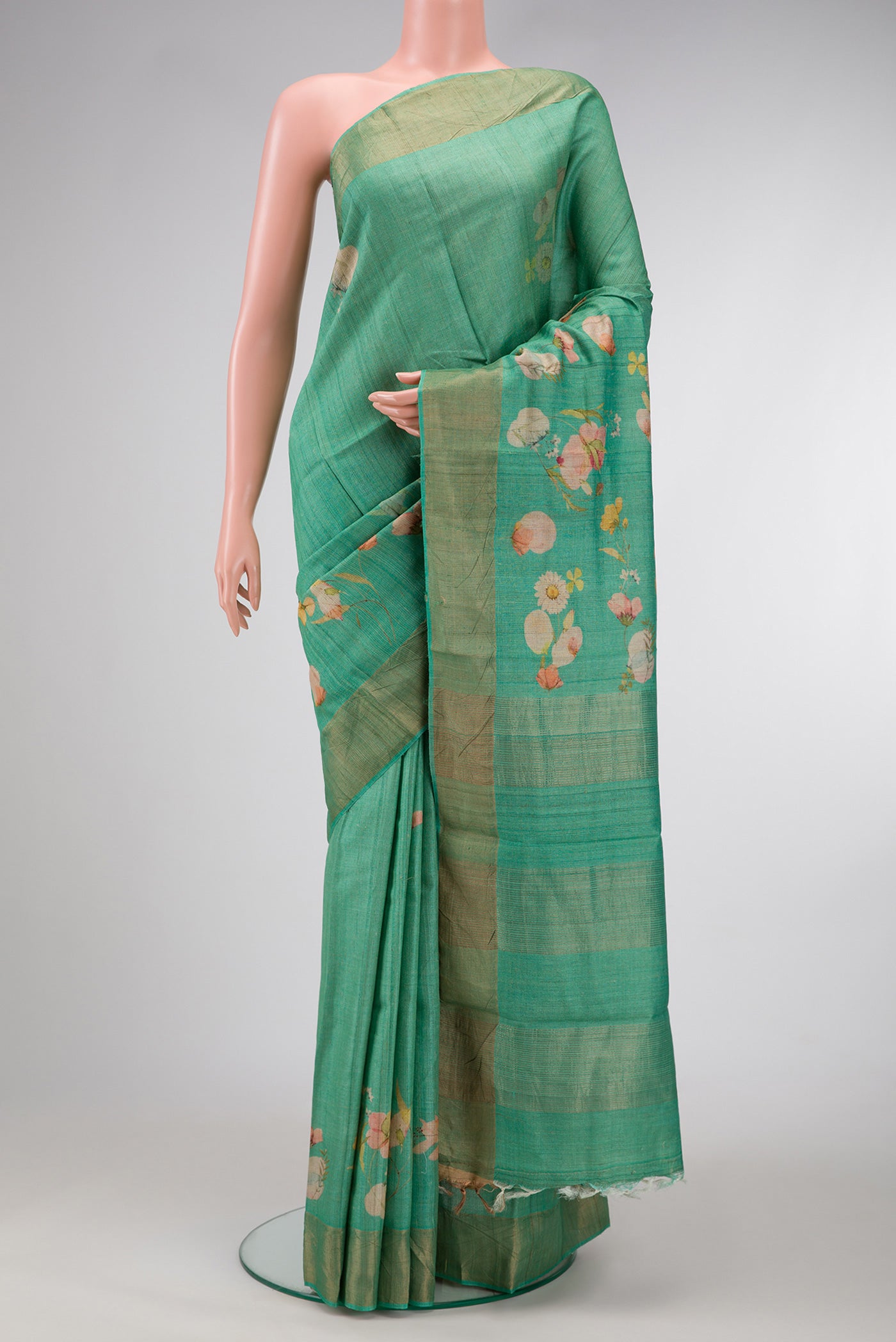 Green Dual Tone Tussar Silk Saree with Printed design on the body and Zari Border.  displayed on a mannequin