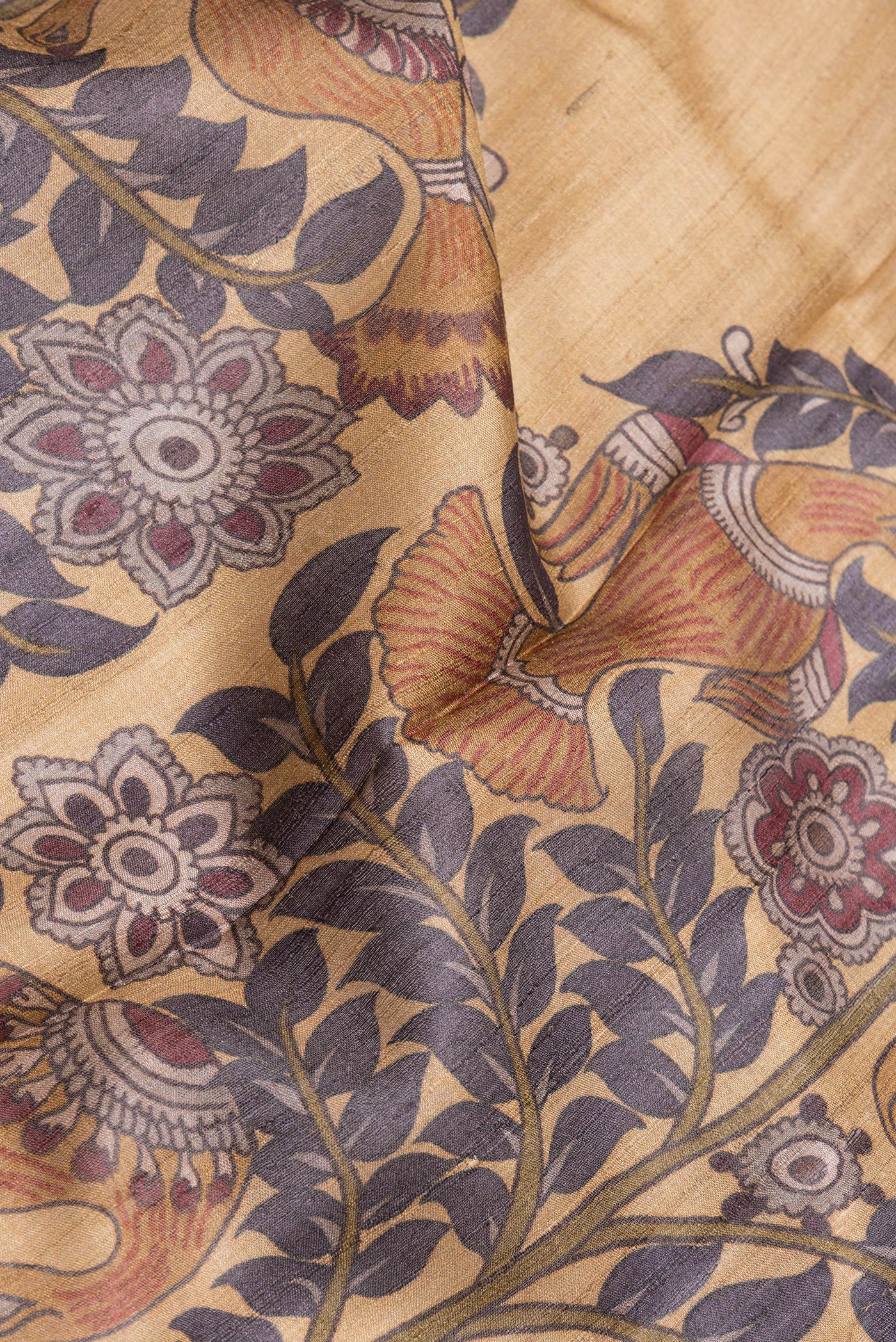 Close up of Mustard Dual Tone Tussar Silk Saree with Printed design on the body and Fancy Border.  displaying folds