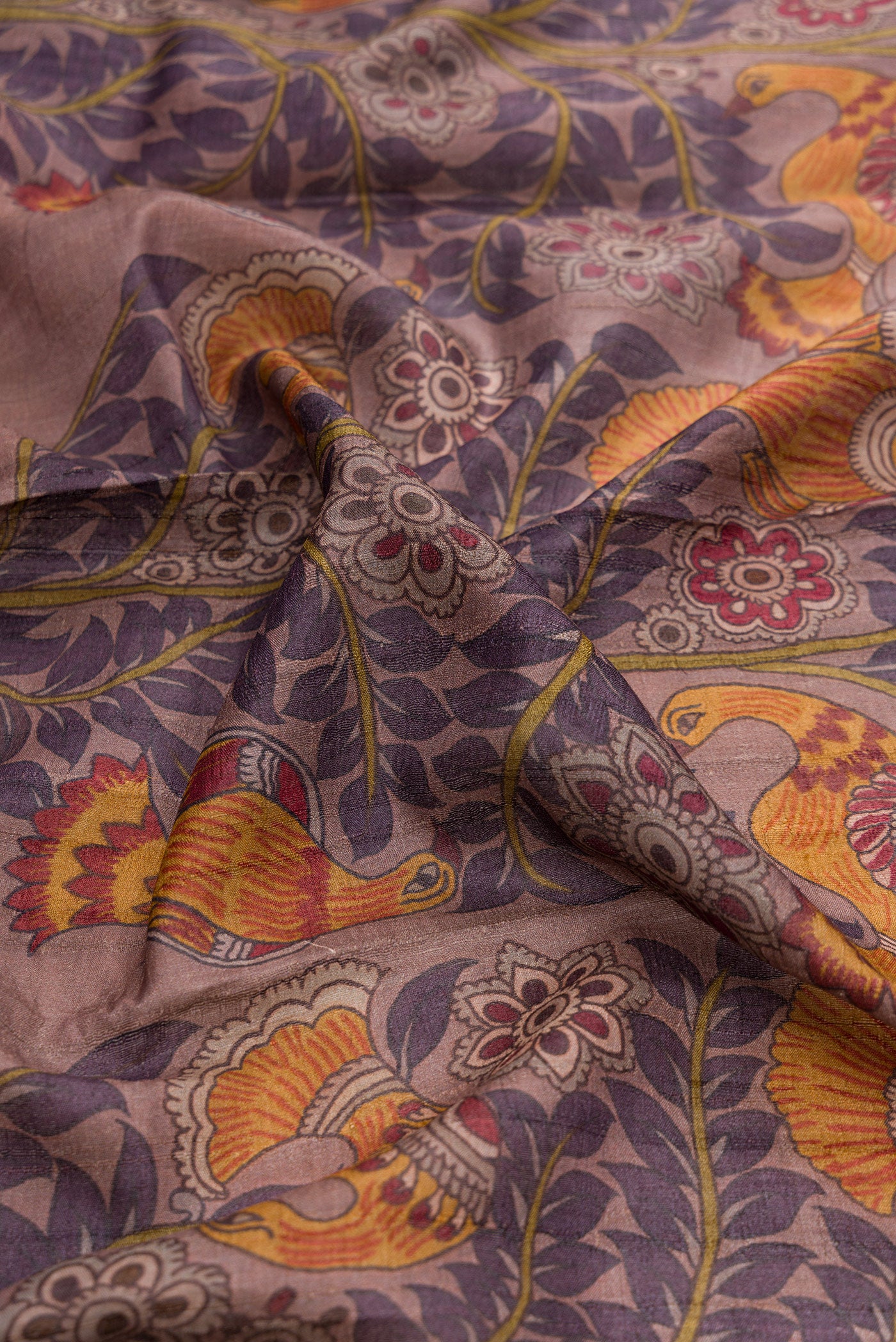 Close up of Purple Dual Tone Tussar Silk Saree with Printed design on the body and Zari Border.  displaying folds