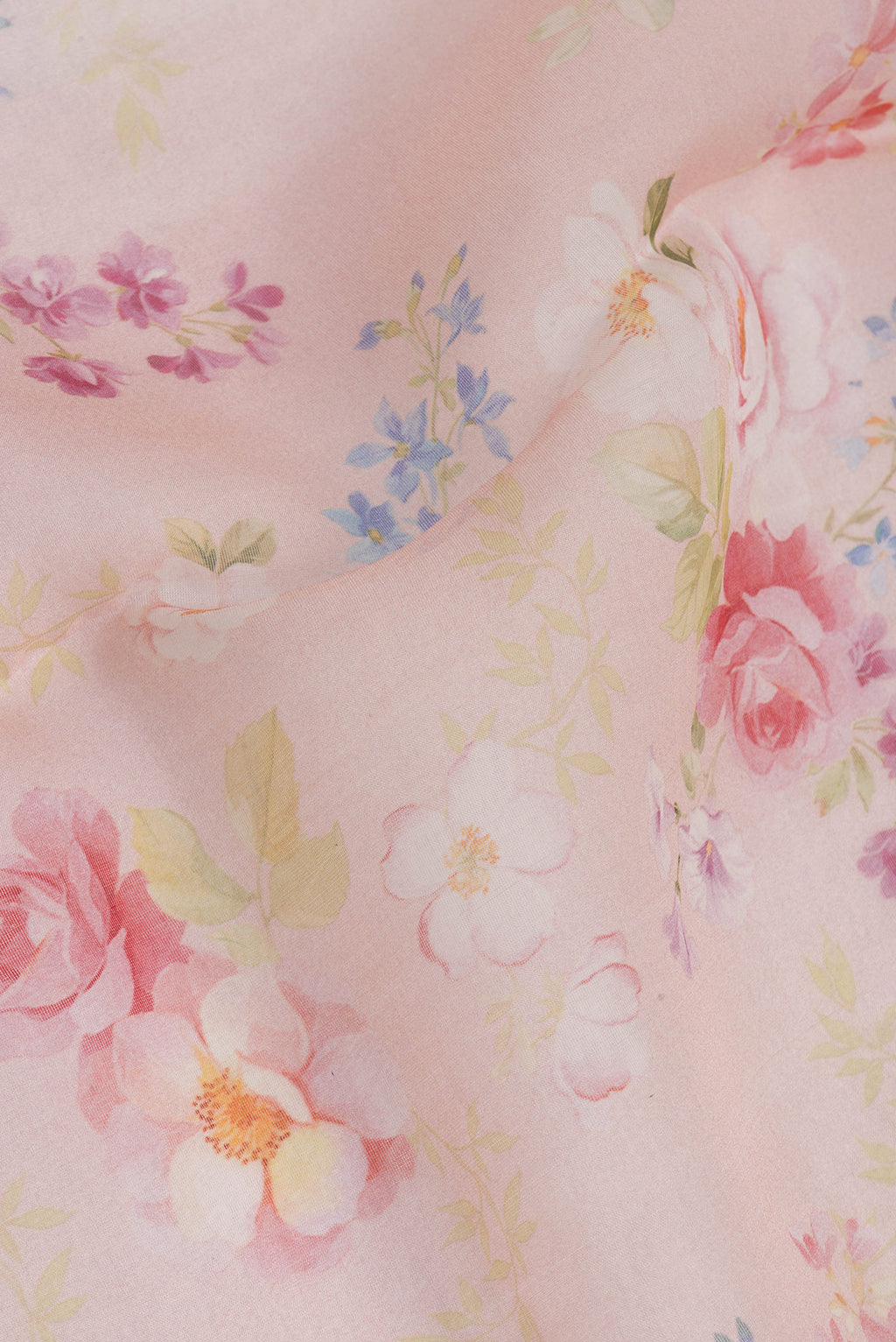 Close up of Rose Gold Organza Silk Saree with Floral Print on the body and Without Border.  displaying folds