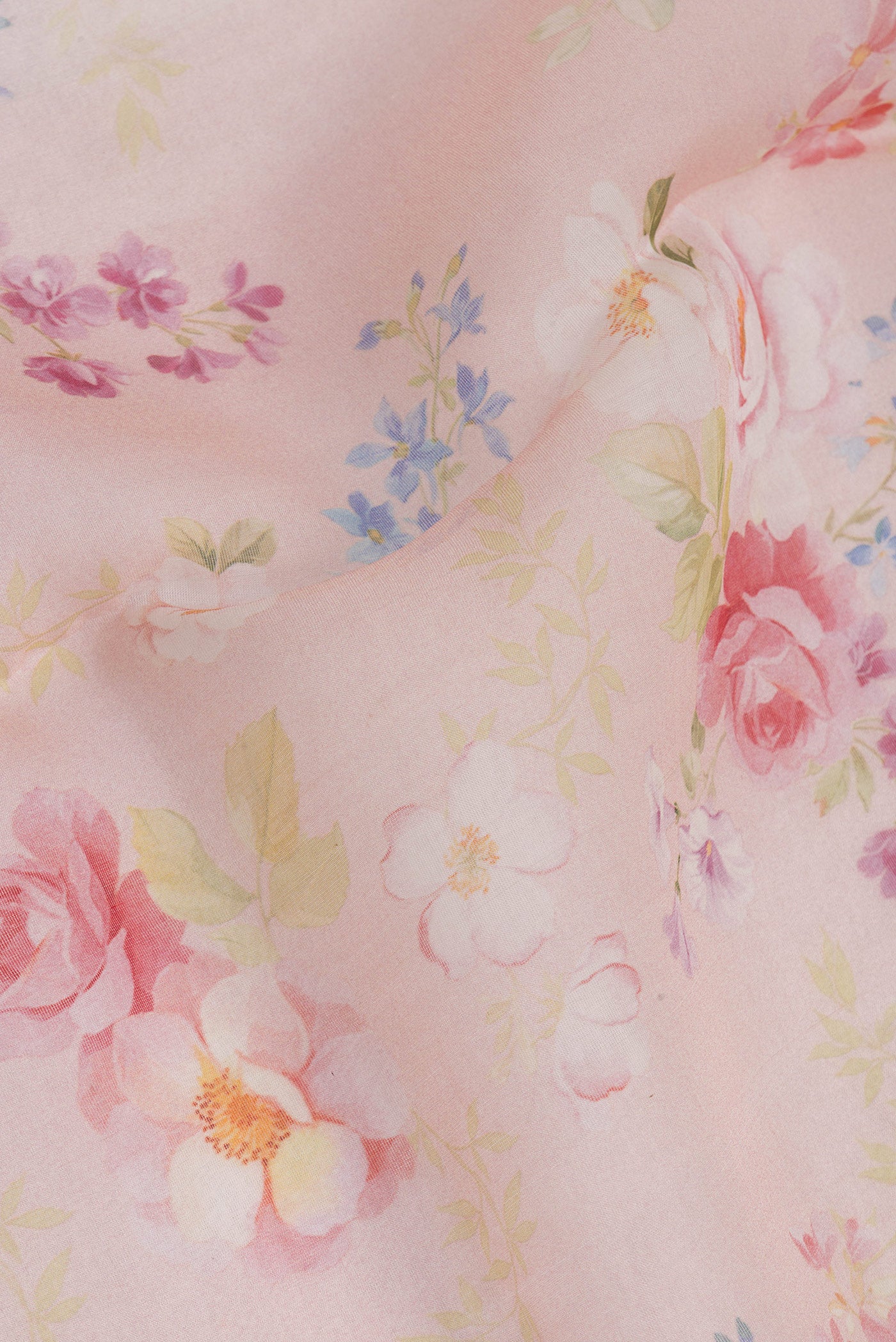 Close up of Rose Gold Organza Silk Saree with Floral Print on the body and Without Border.  displaying folds