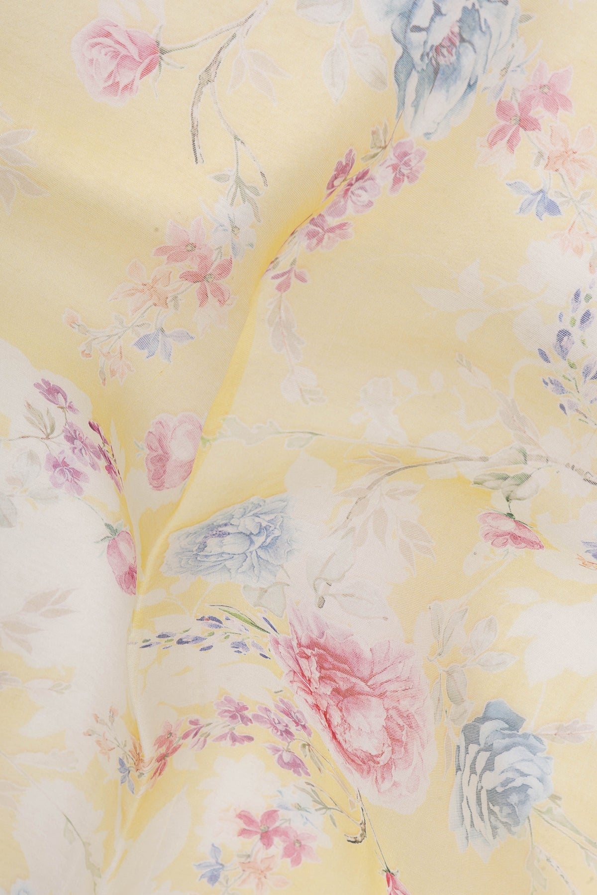 Close up of Lemon Yellow Organza Silk Saree with Printed design on the body and Without Border.  displaying folds