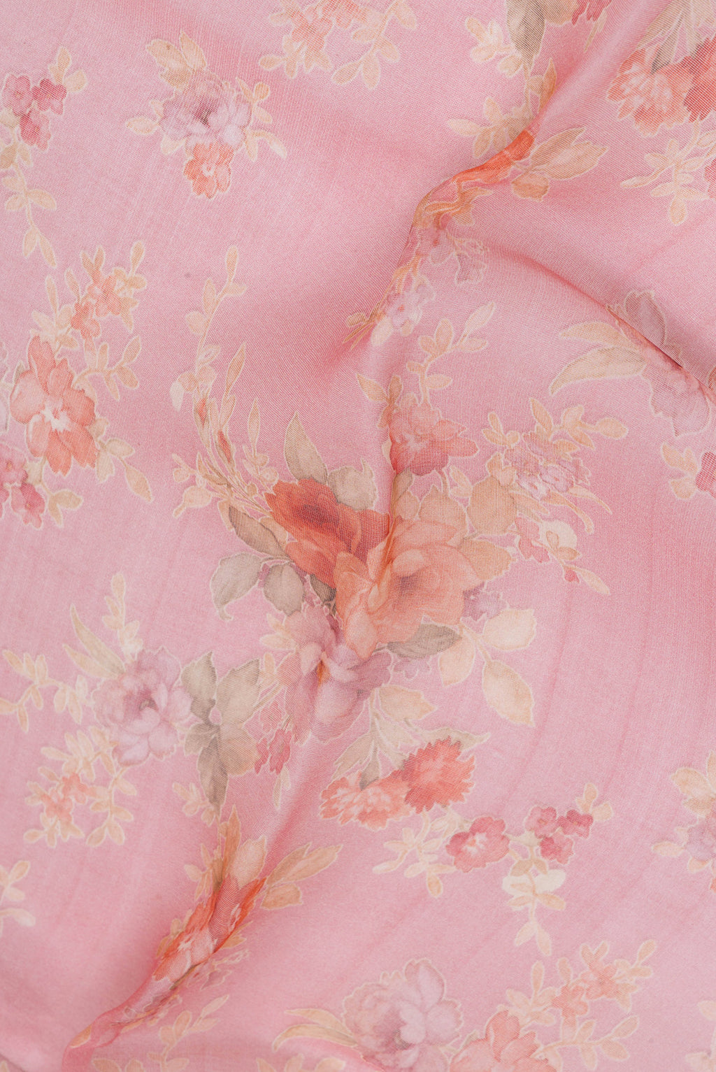 Close up of Pink Organza Silk Saree with Floral Print on the body and Without Border.  displaying folds