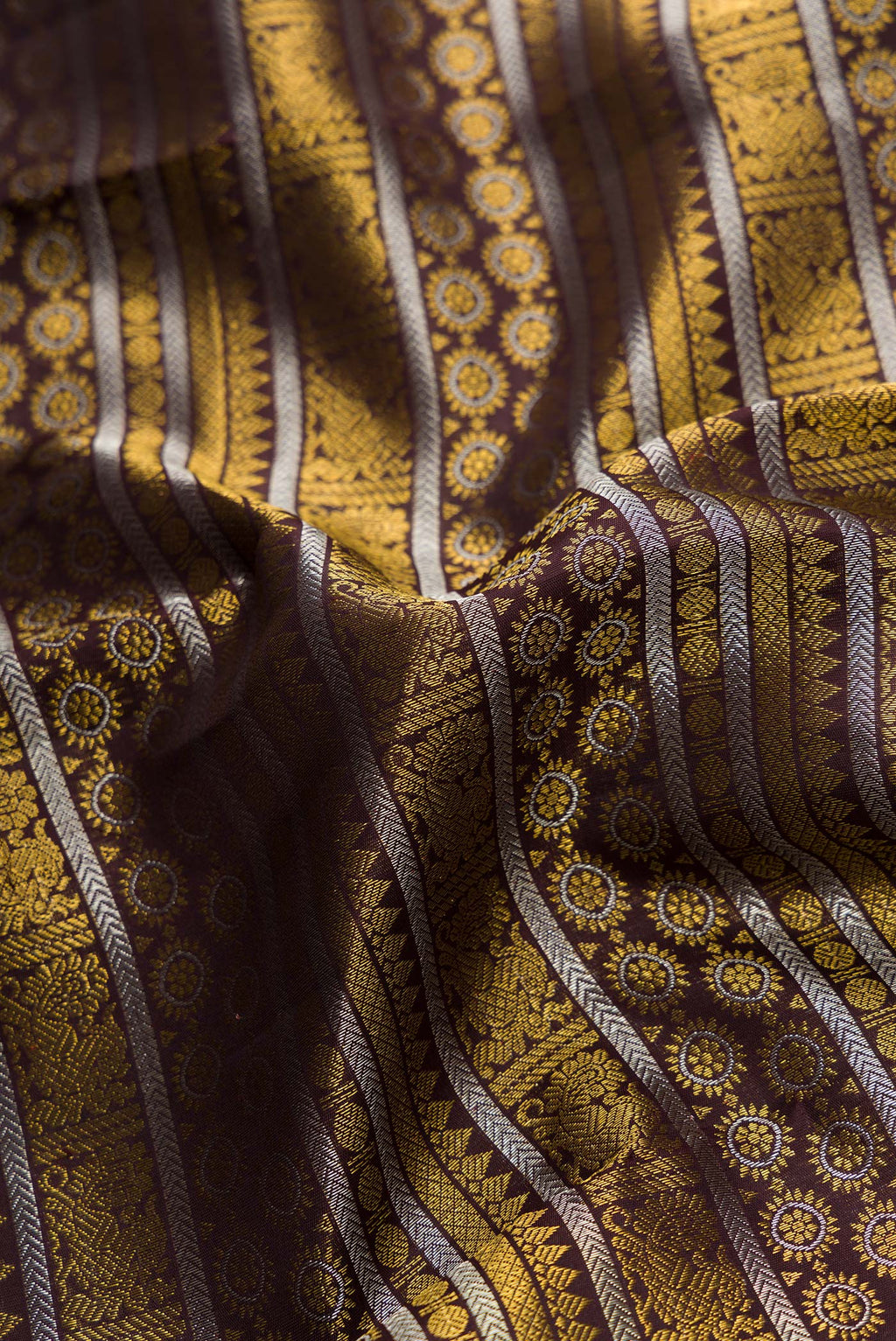 Close up of Coffee Brown Dual Tone Kanchipuram Silk Saree with Zari Brocade on the body and Fancy Border.  displaying folds
