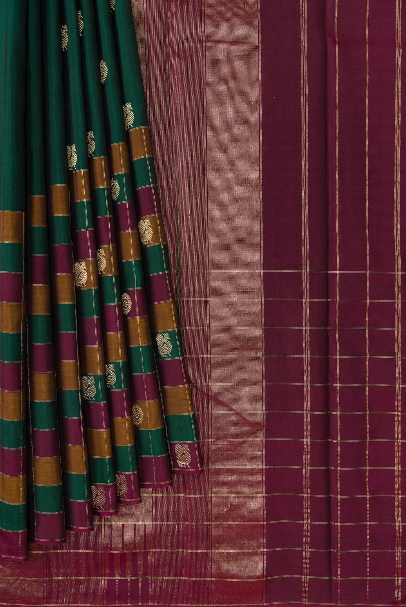 Pleats and pallu of Bottle Green Dual Tone Kanjivaram Silk Saree with Zari Butta on the body and Checks Border. 