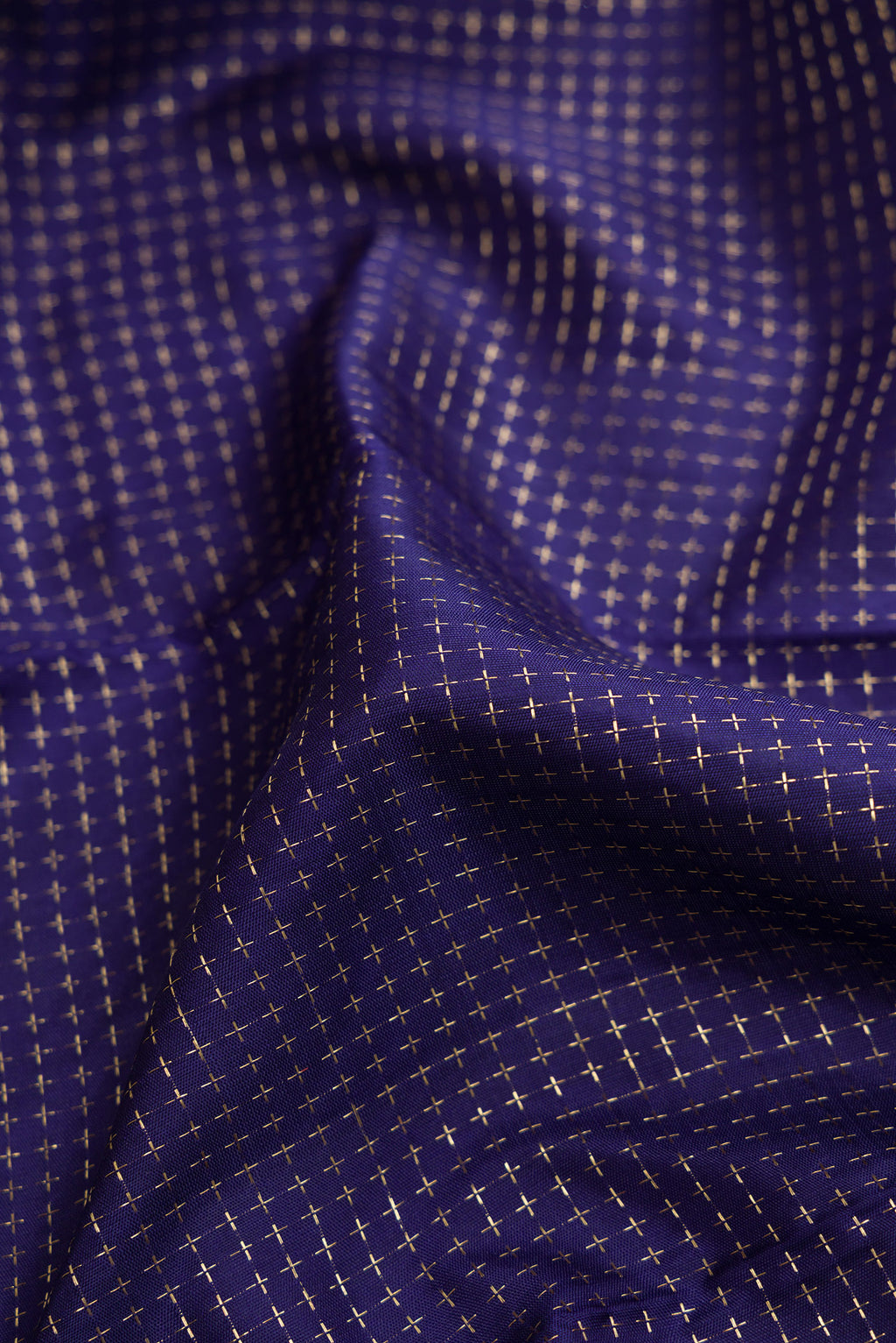 Close up of Navy Blue Dual Tone Kanjivaram Silk Saree with Checked design on the body and Zari Border.  displaying folds